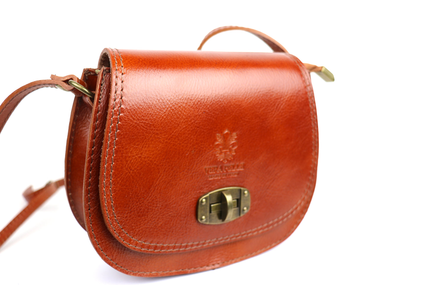 Side view of the light tan Cora Vintage Small Leather Crossbody Bag, showing the brass clasp and smooth leather design.