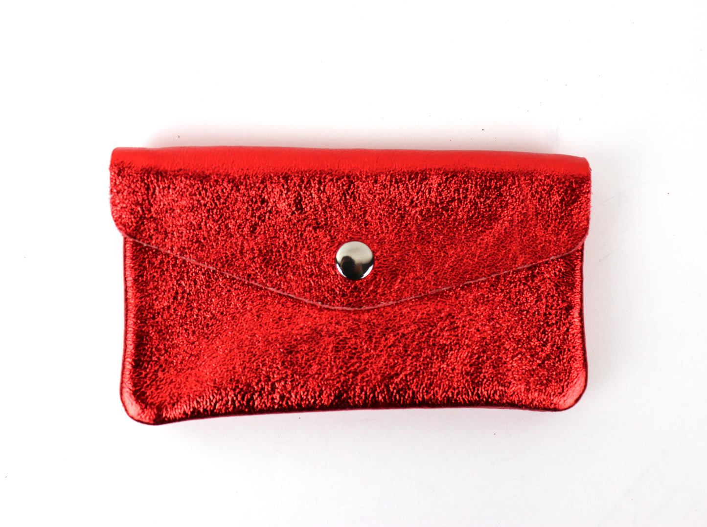 Front view of an orange metallic pouch, featuring a shiny textured surface and a central button clasp.