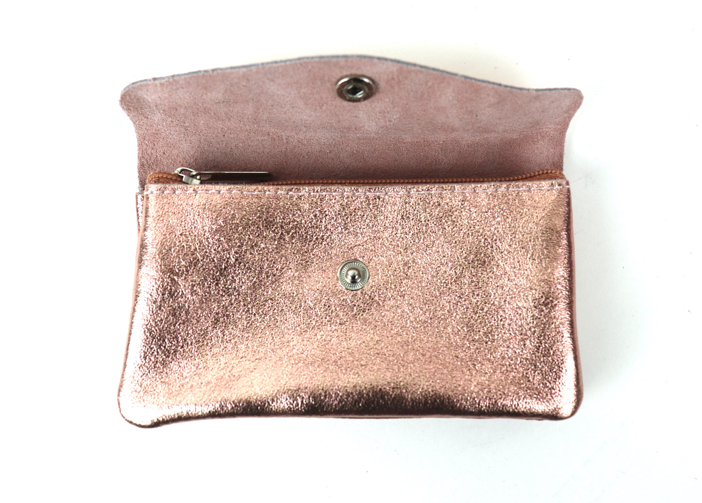 Opened view of a rose gold metallic pouch, displaying the interior and button clasp.
