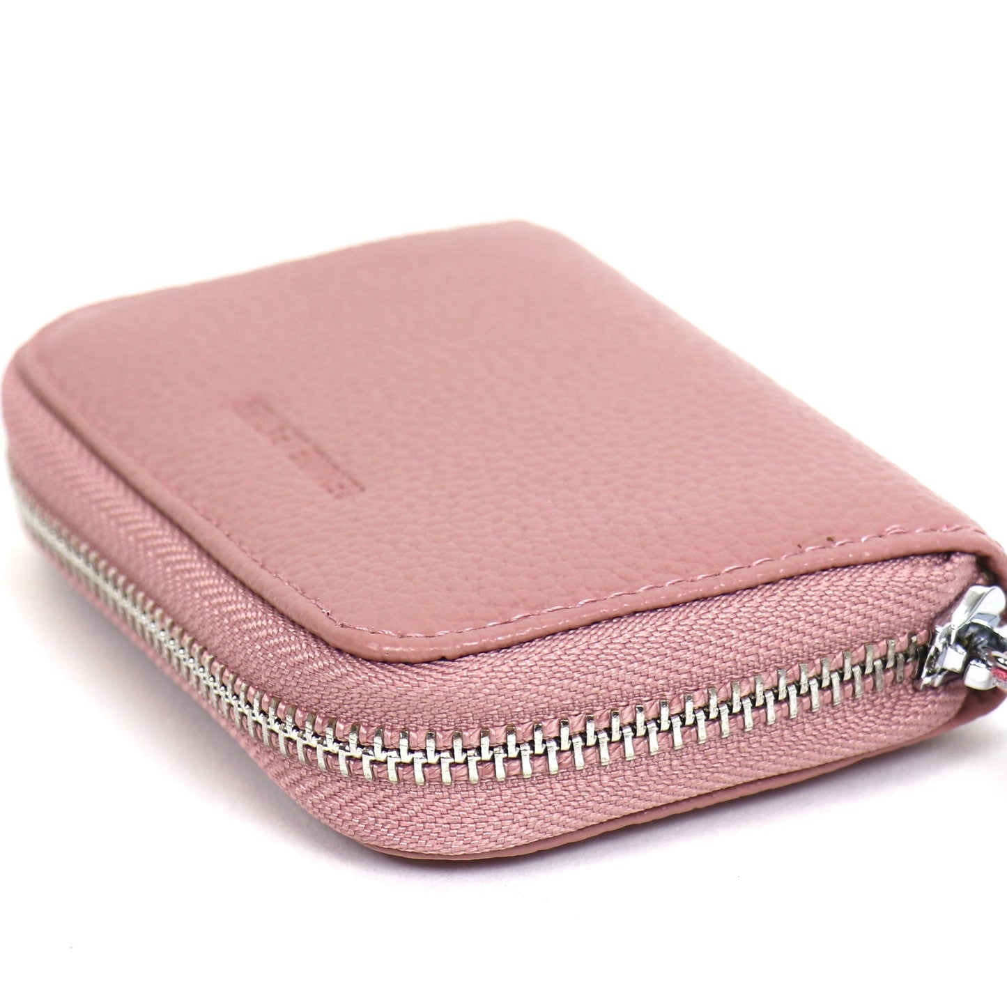 Small leather card holder wallet in dusty pink, displayed at an angle, showing the zipper and smooth texture.
