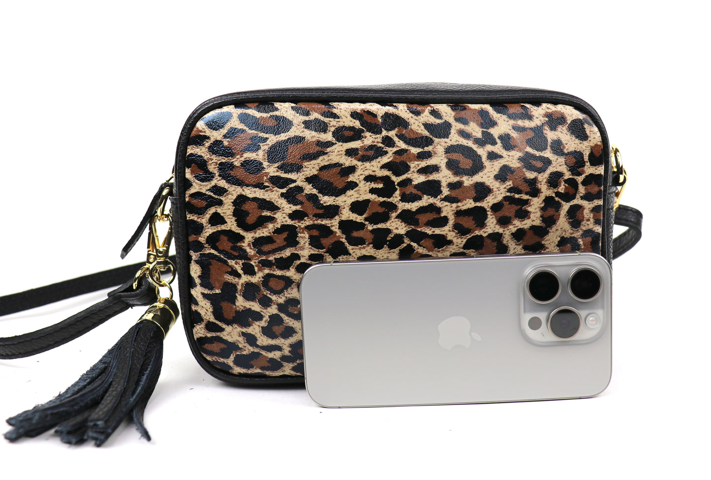 Leather Leopard print bag next to a smartphone, highlighting the bag's size.