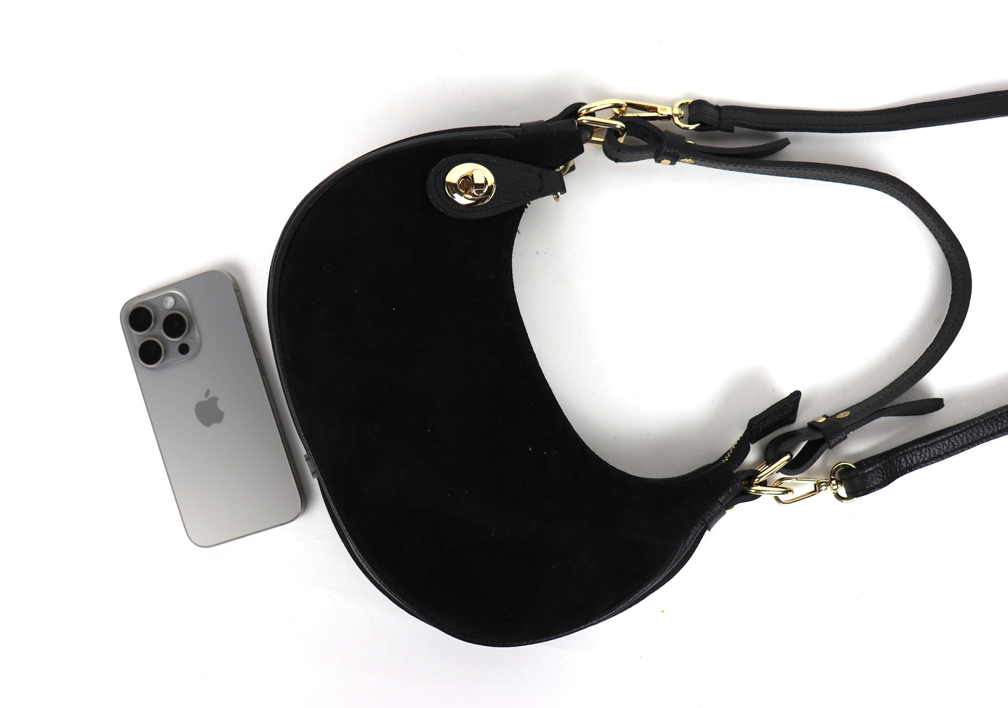 Black half moon bag laid flat with iPhone.