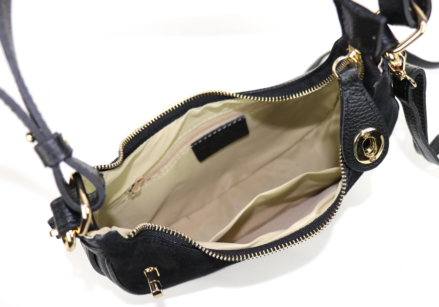 Black half moon bag interior view with contents.