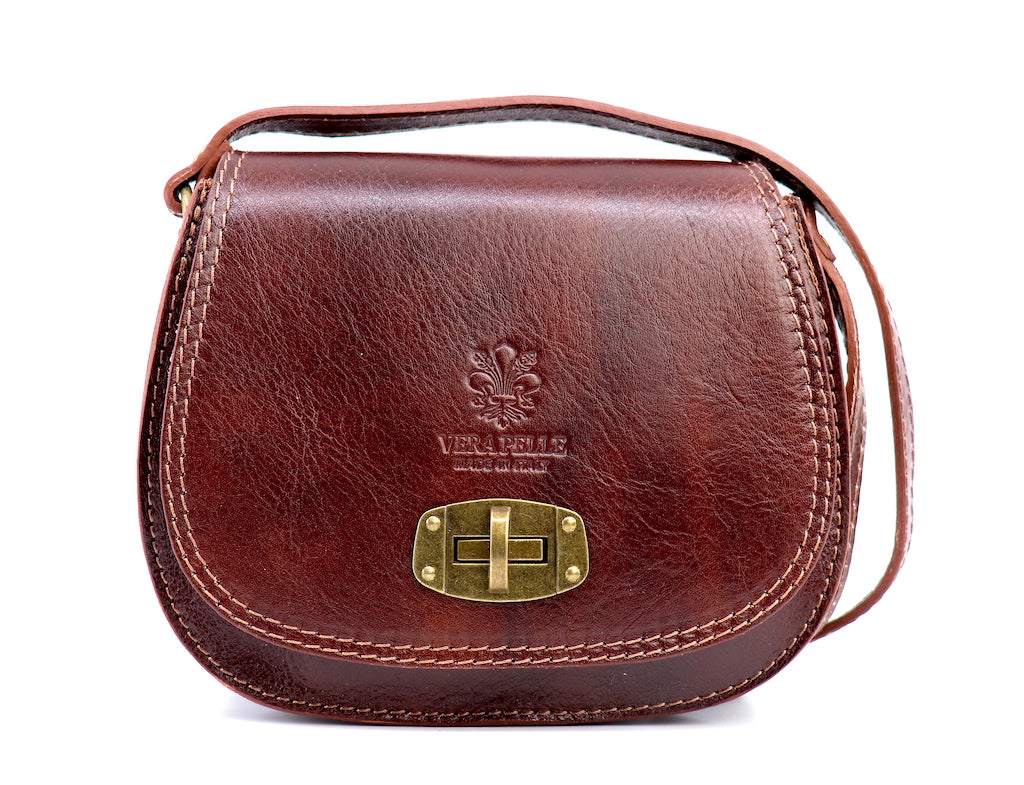 Front view of a dark tan Cora Vintage Small Leather Crossbody Bag featuring a brass lock clasp and textured leather, displayed on a white background.