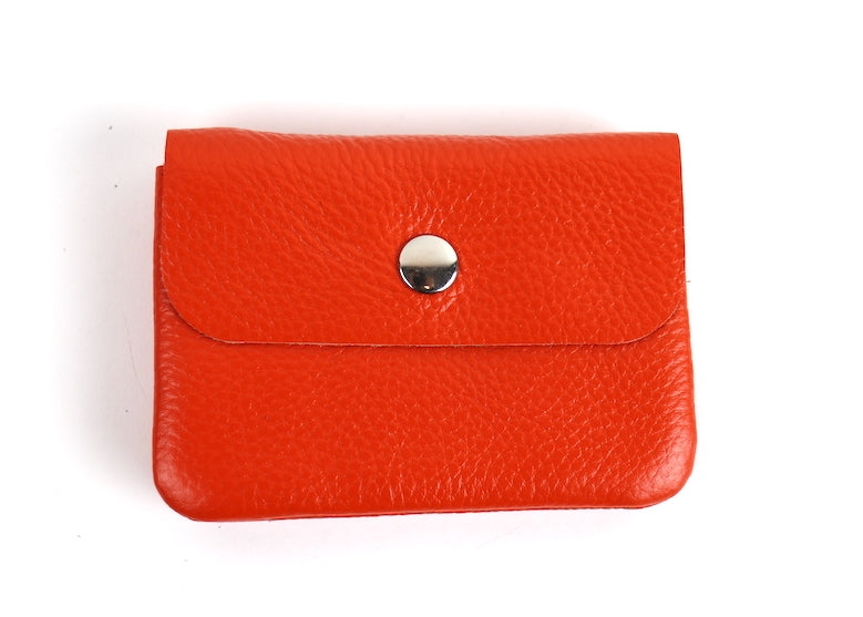 Orange Wallet: A small bright orange leather wallet with a silver snap button.