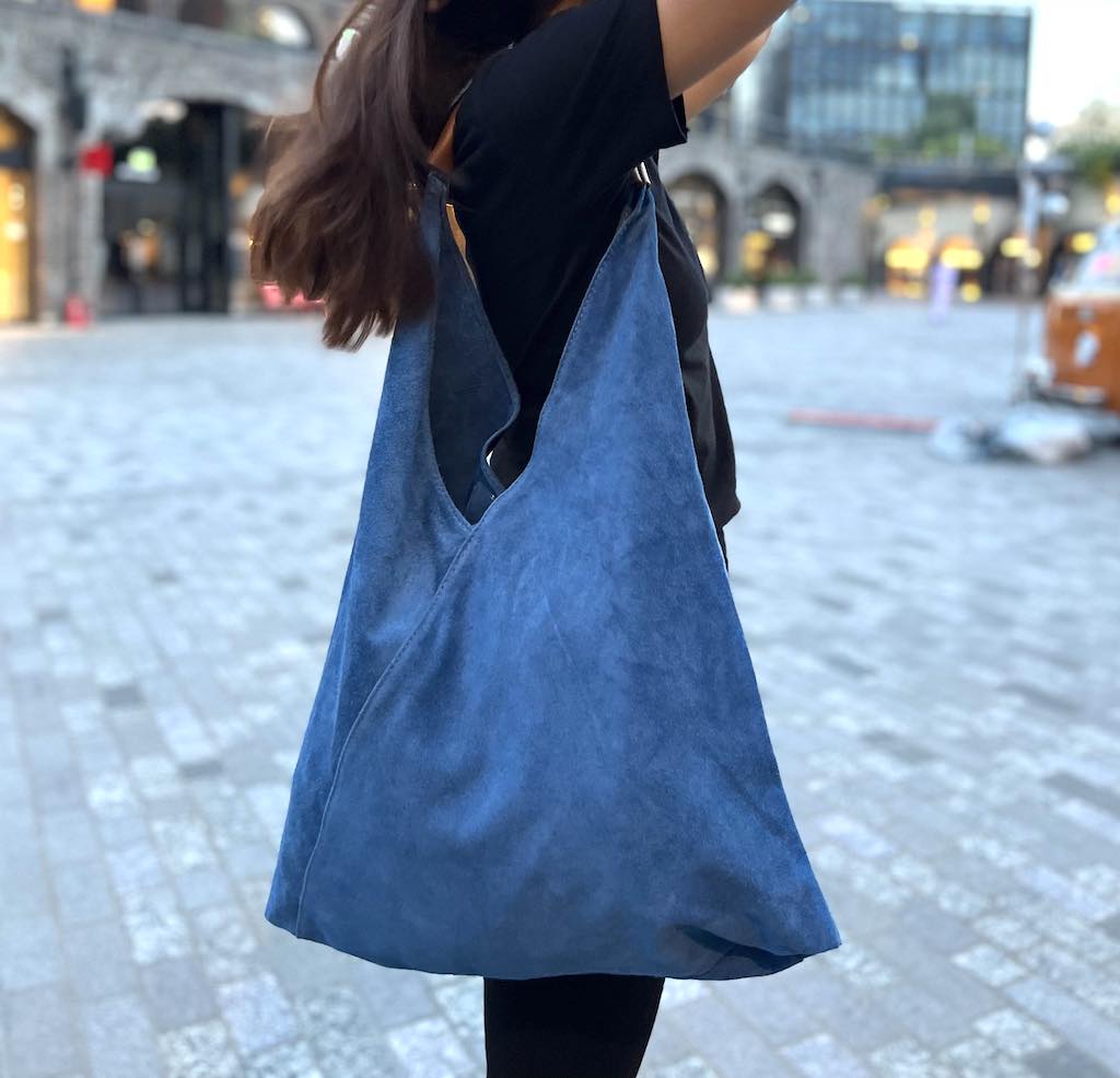 Model wearing the Denim Blue Samantha Large Tote Laptop Bag while walking outdoors in a city setting.