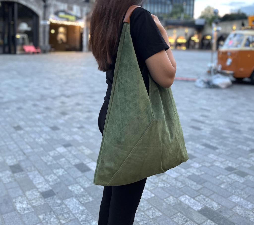 Model wearing the Olive Green Samantha Large Tote Laptop Bag outdoors with a retro-style van in the background.