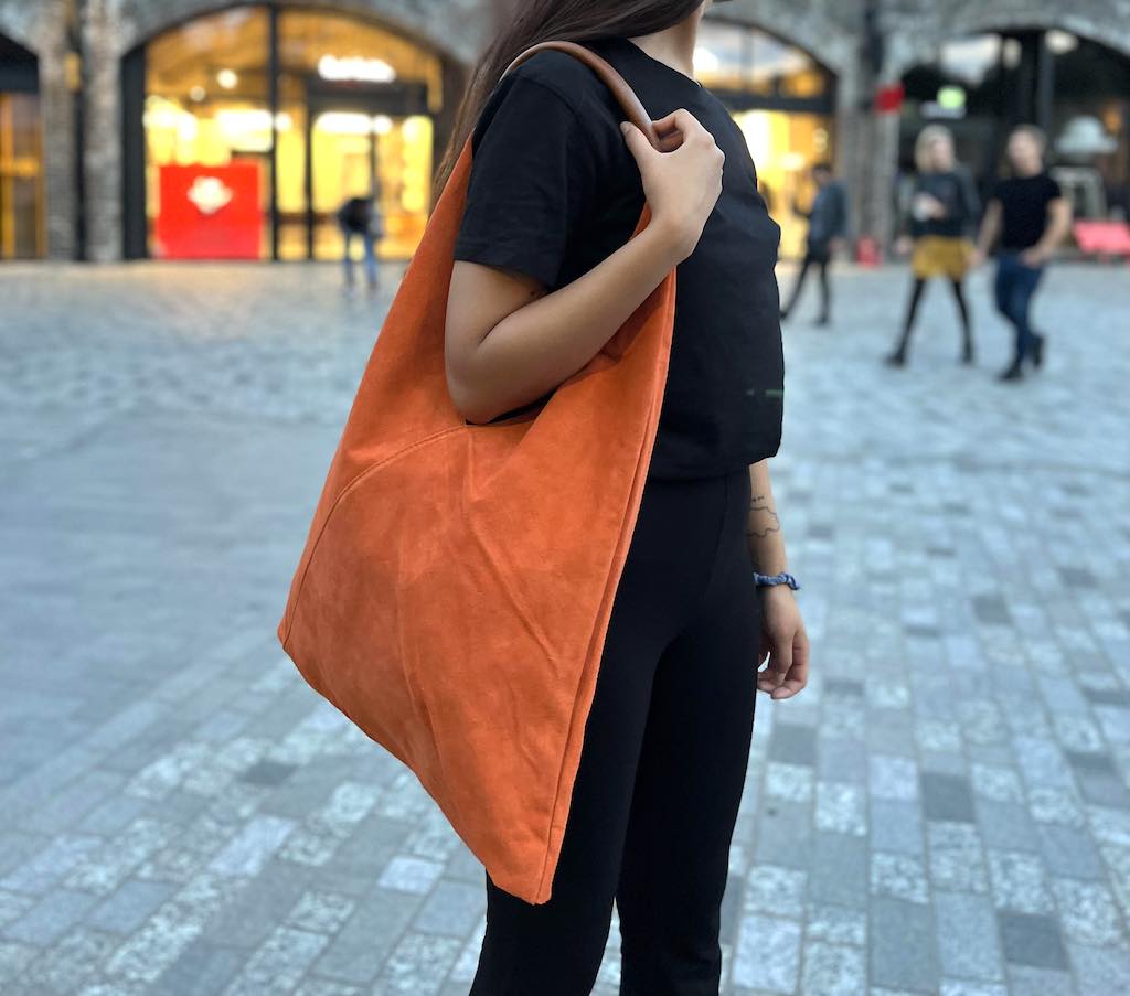 Model wearing the Black Samantha Tote over the shoulder.