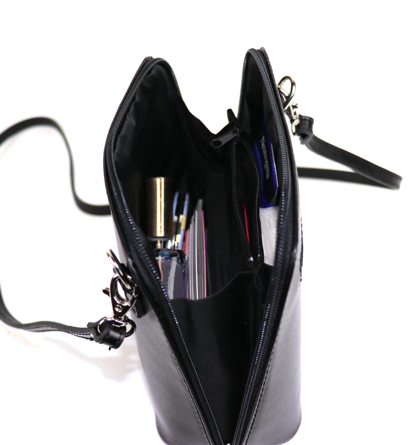 Black Small Handmade Leather Crossbody Bag, angled top view showing interior contents.
