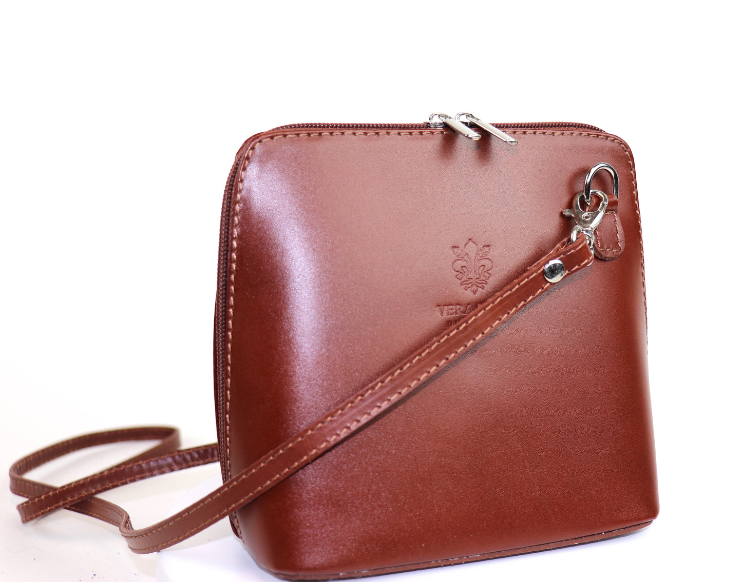 Burgundy Small Handmade Leather Crossbody Bag, side view showcasing its structure and elegant color.
