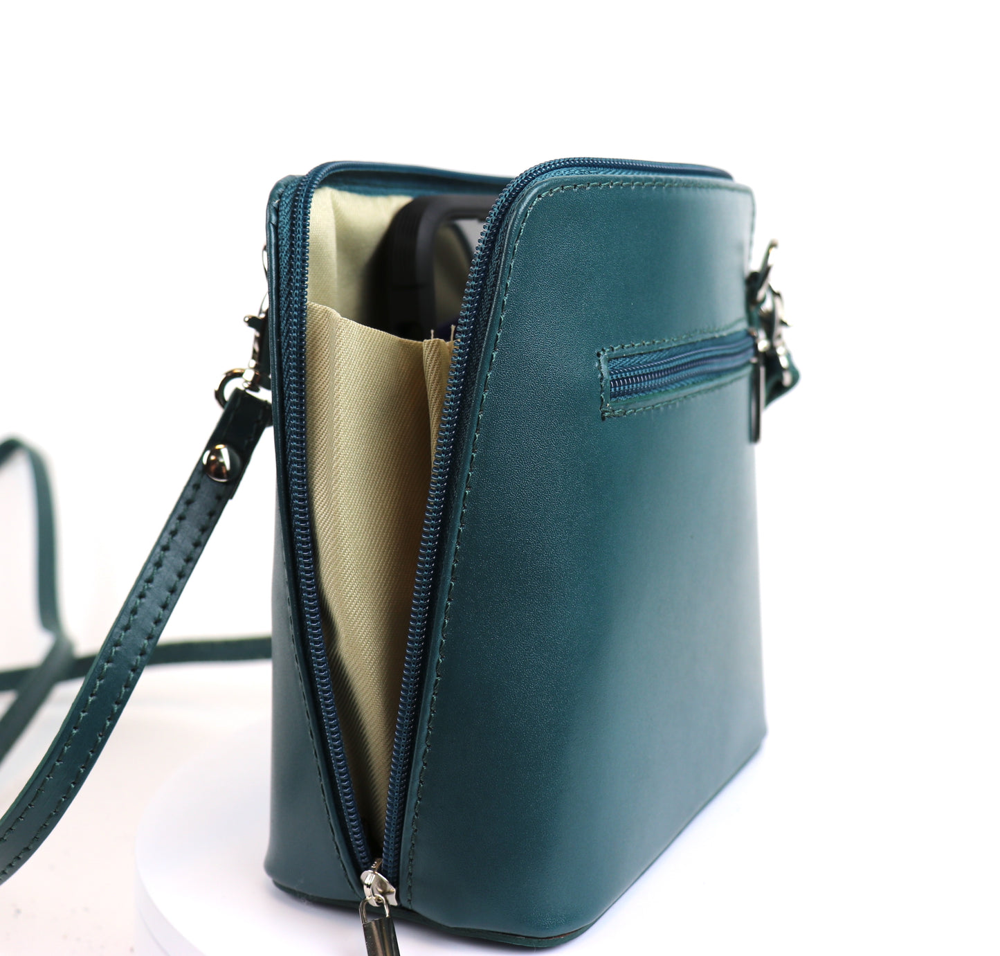 Dark Turquoise Small Handmade Leather Crossbody Bag, angled side view with a rich blue-green color.
