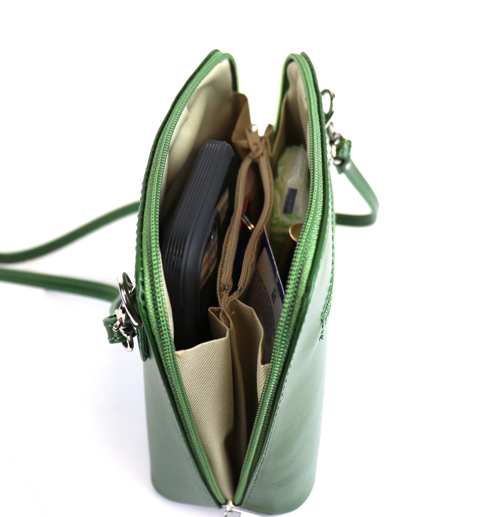 Green Small Handmade Leather Crossbody Bag, top view showing the interior compartments with contents.
