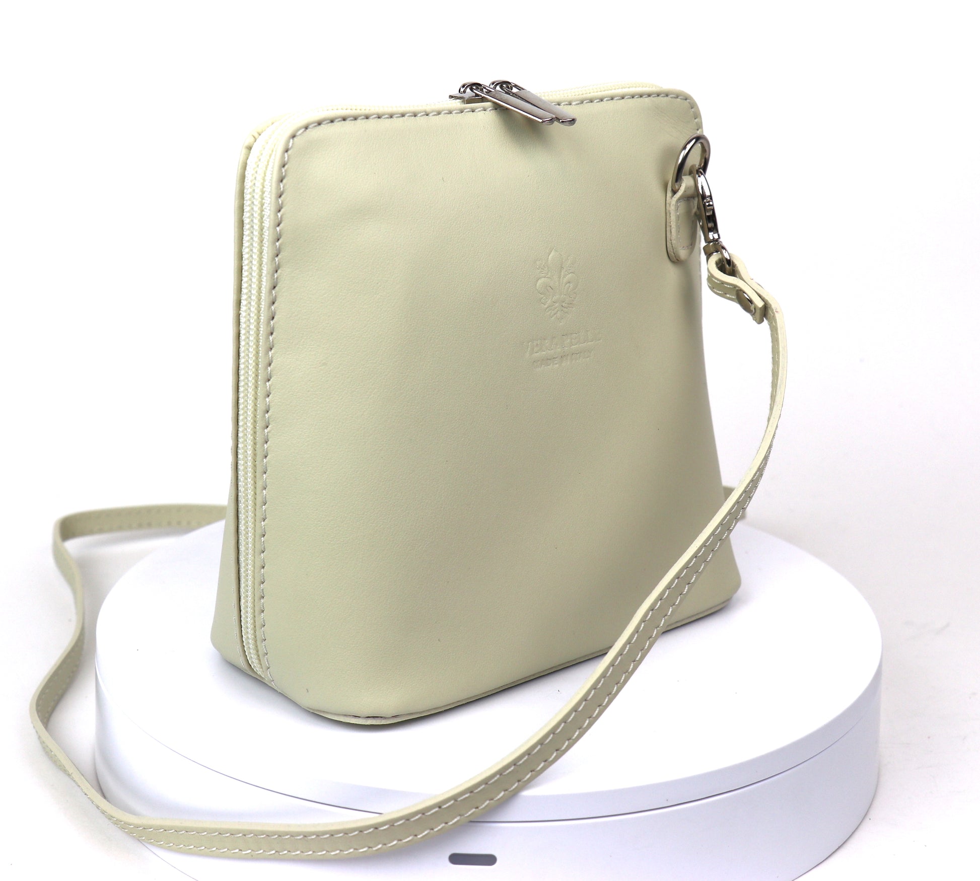 Cream Small Handmade Leather Crossbody Bag, side view with a soft cream color and structured shape.
