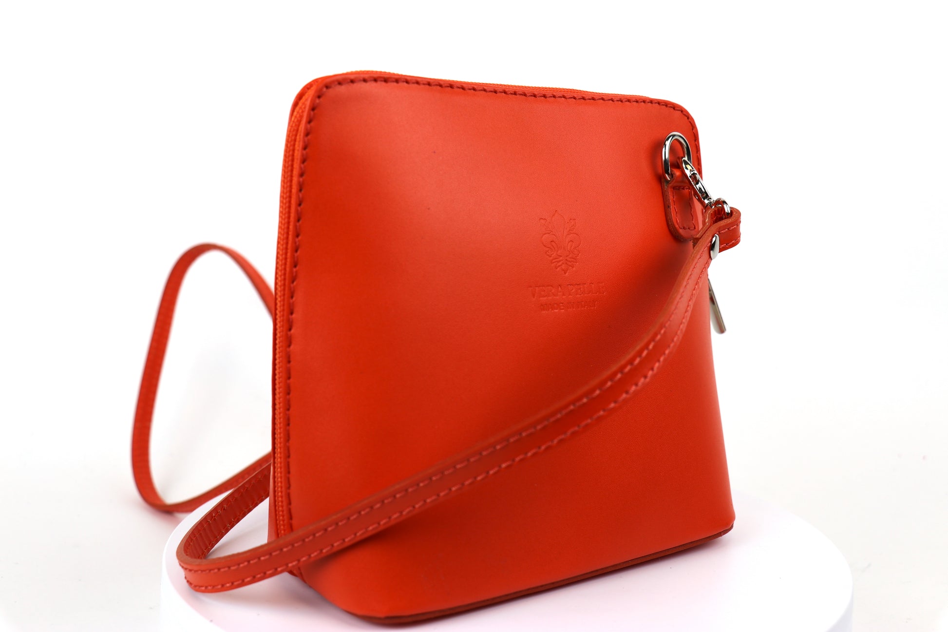 Burnt Orange Small Handmade Leather Crossbody Bag, side view featuring a bright orange tone.
