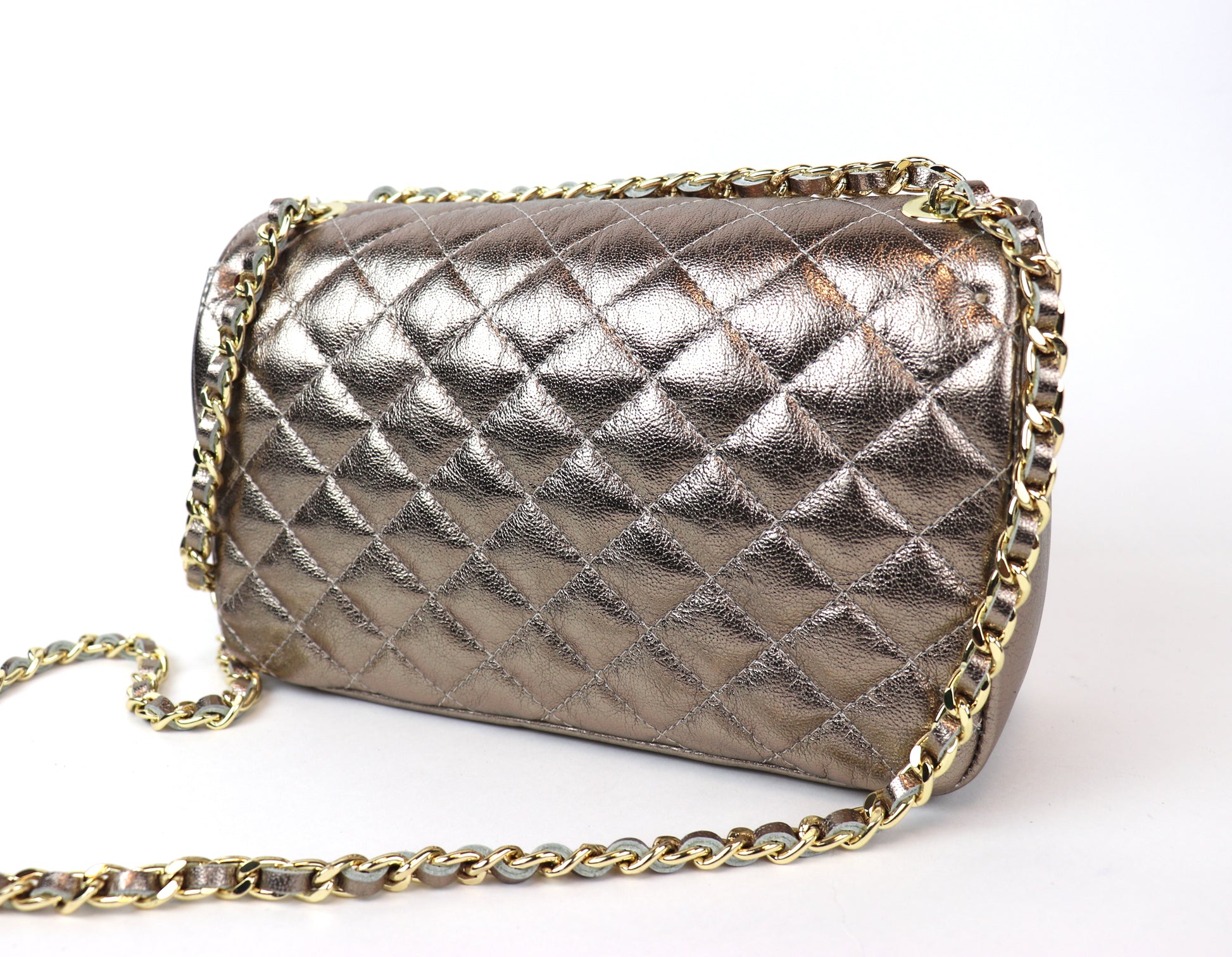 Back view of a bronze quilted leather bag with a gold chain strap.