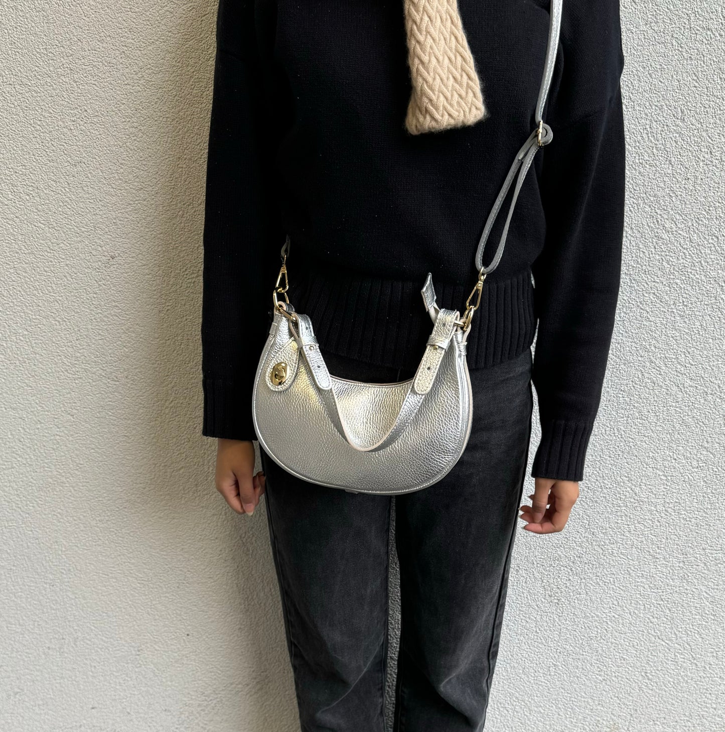 Person wearing Silver half moon bag as a crossbody bag.
