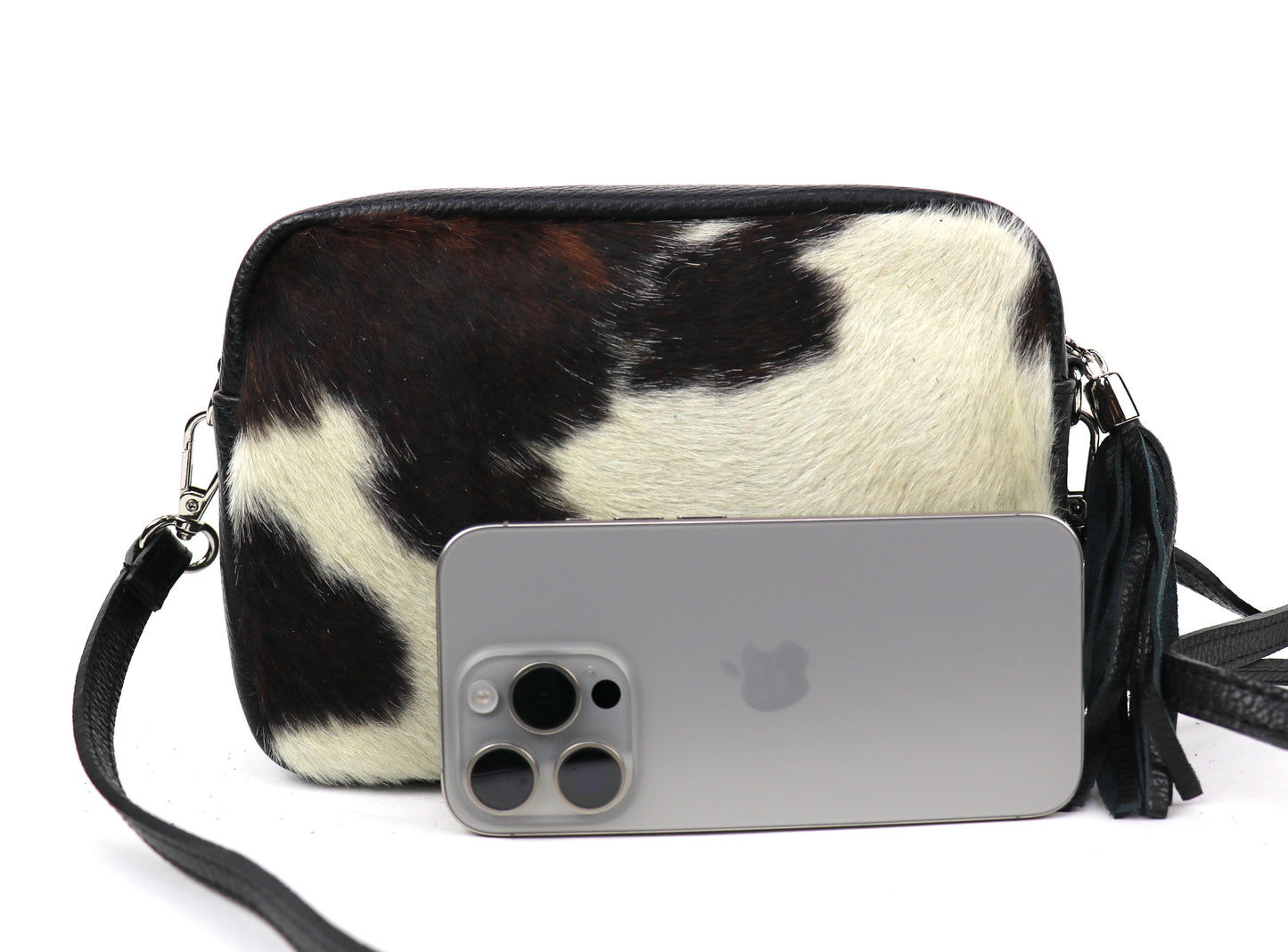 Pony print leather bag next to a smartphone, highlighting the size of the bag.