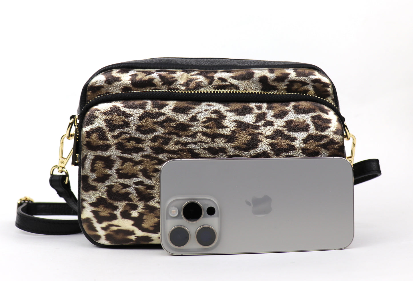 Gold Leopard print leather bag next to a smartphone, showing the bag's size relative to the phone.