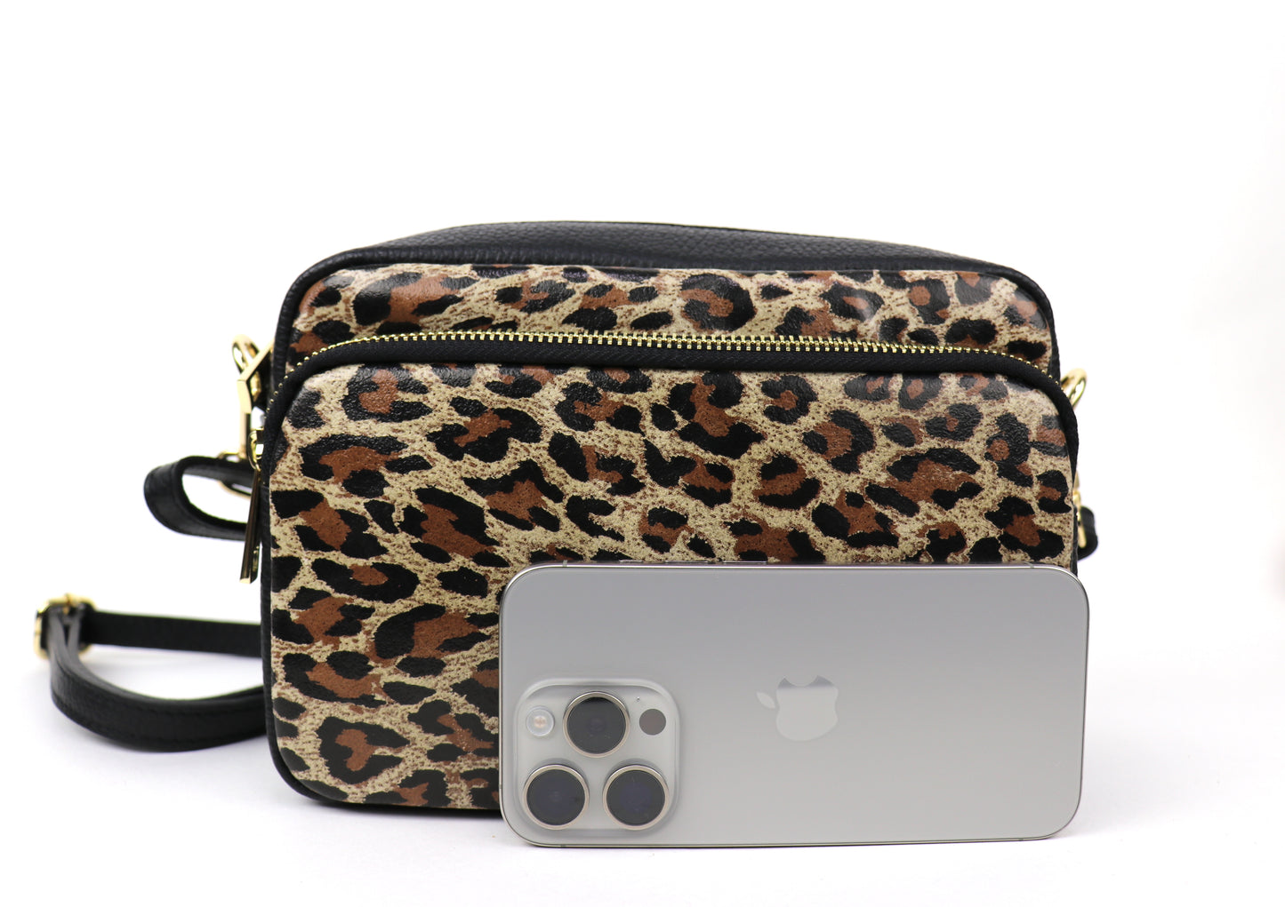 Leather Leopard print leather bag next to a smartphone, highlighting the size of the bag.