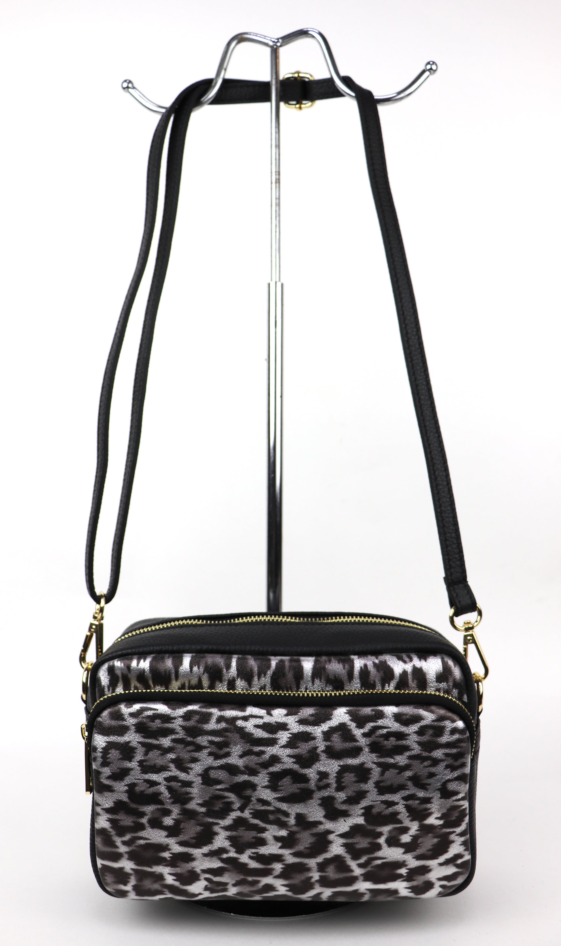 Silver Leopard print leather bag with a long strap, displayed hanging against a white background.