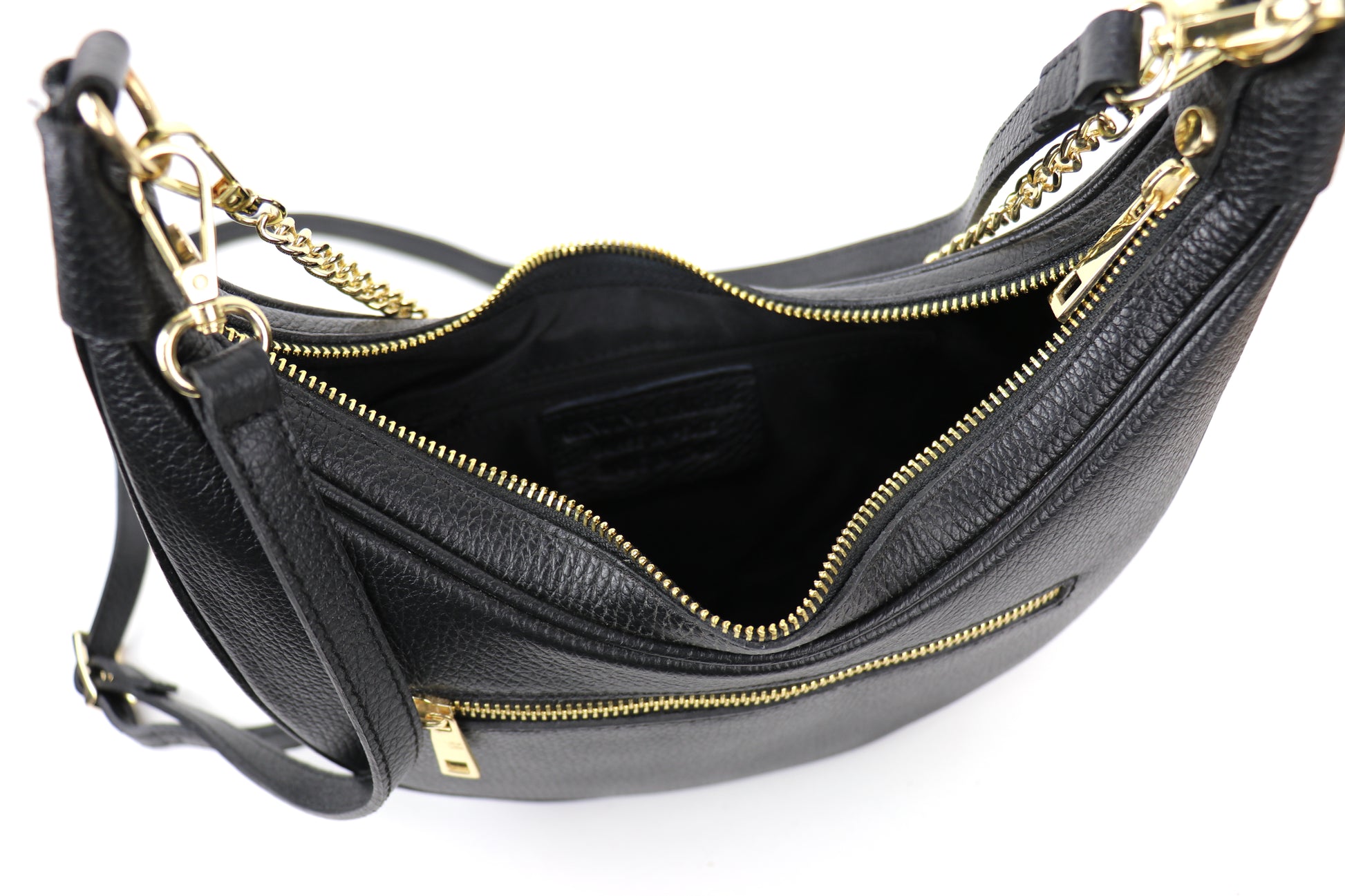 A black leather bag shown from above, with the top zipper open, revealing the interior space.