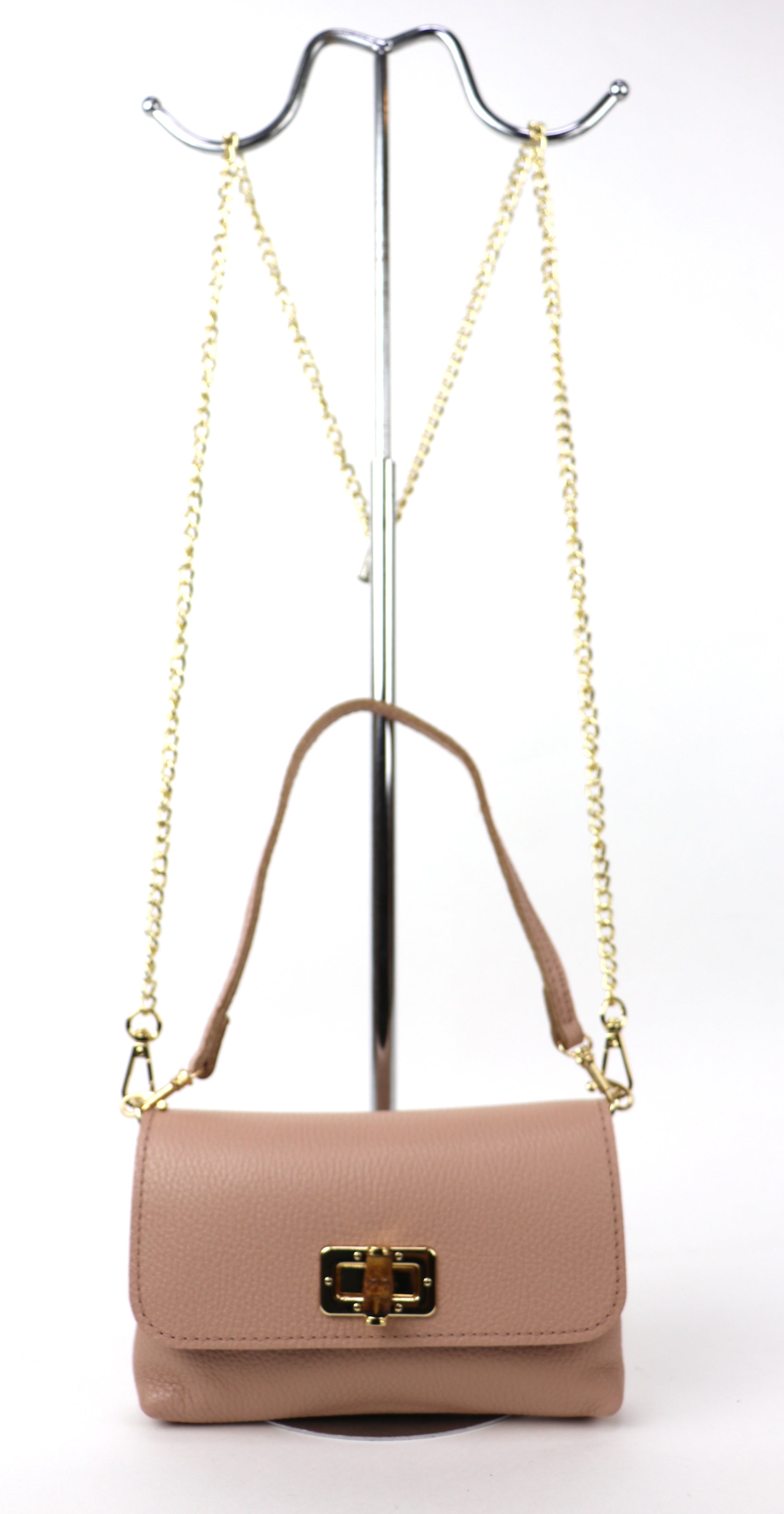 Dusty pink leather bag hanging from a gold chain, displaying its full silhouette.