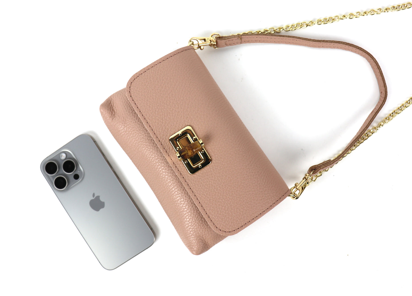 Dusty pink leather bag next to a smartphone, illustrating the bag’s size.