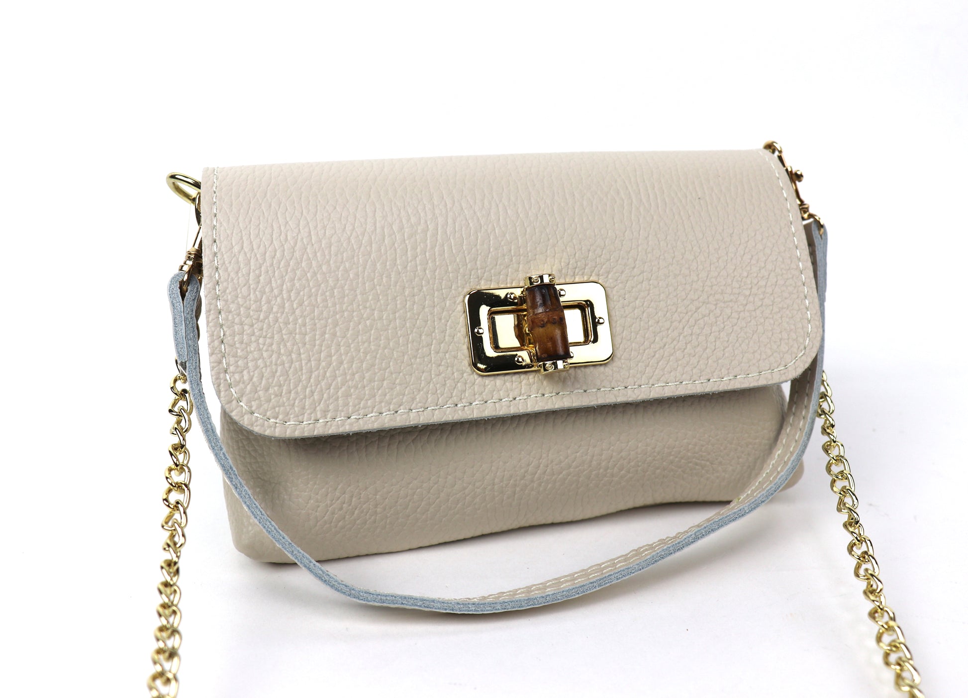 Cream leather bag with a gold clasp and chain, showing the front panel.