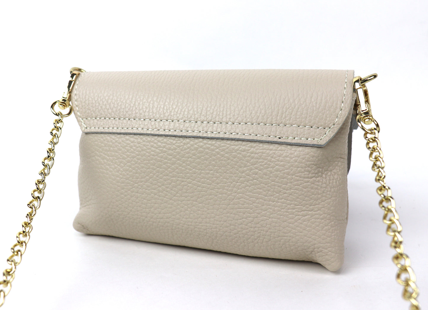 Back view of a cream leather bag, showing the smooth leather surface and gold chain.
