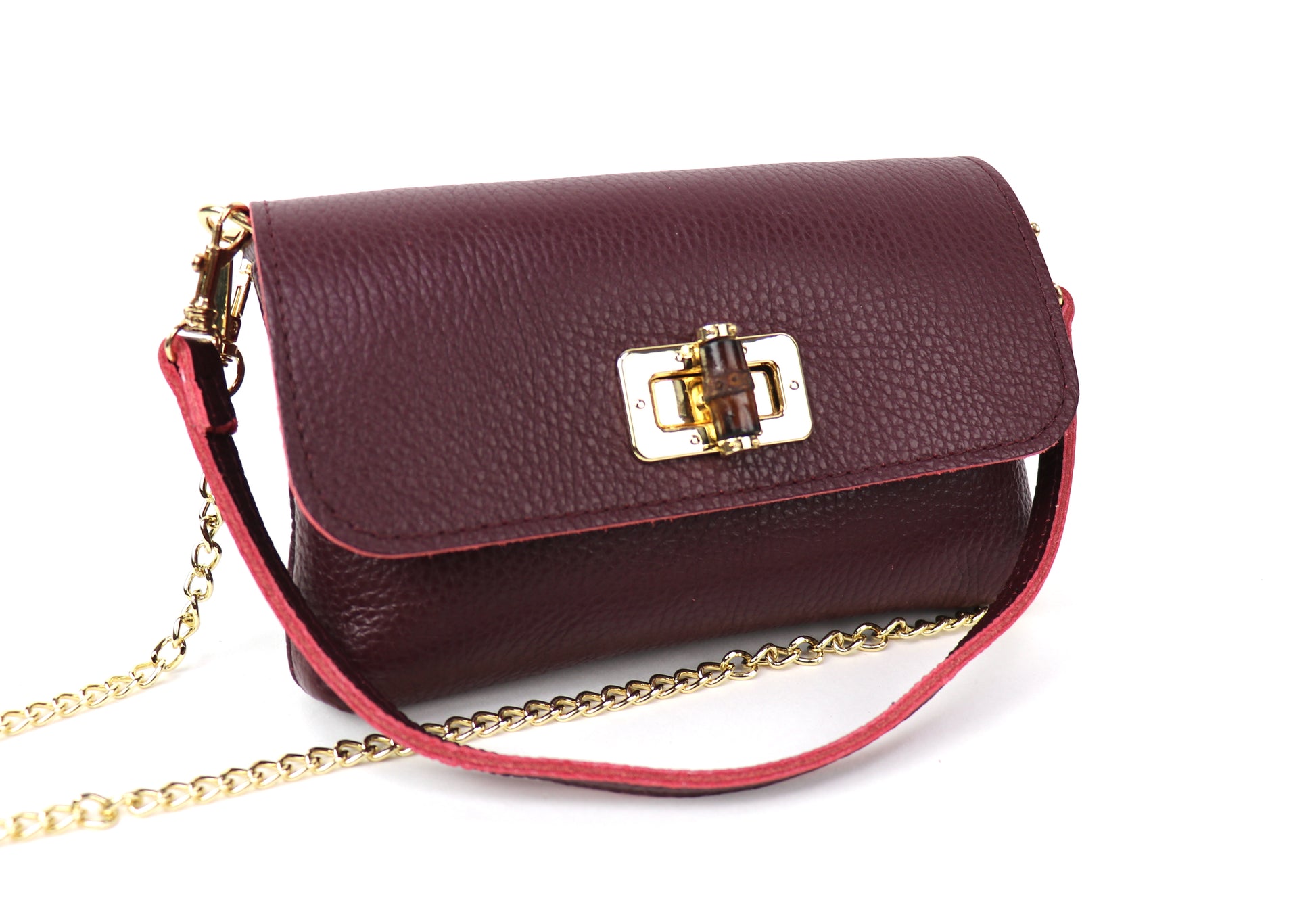 Burgundy Leather Bag: Burgundy leather bag with a gold chain and clasp, displayed flat.
