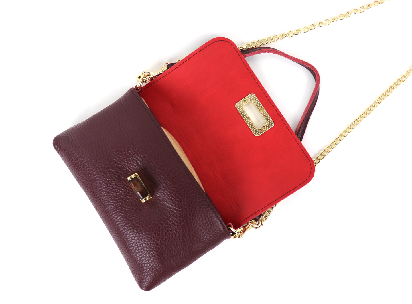 Burgundy leather bag with a gold clasp and chain, displayed in an open view. The interior is lined with red leather, showcasing the inner compartments and gold detailing on the clasp.