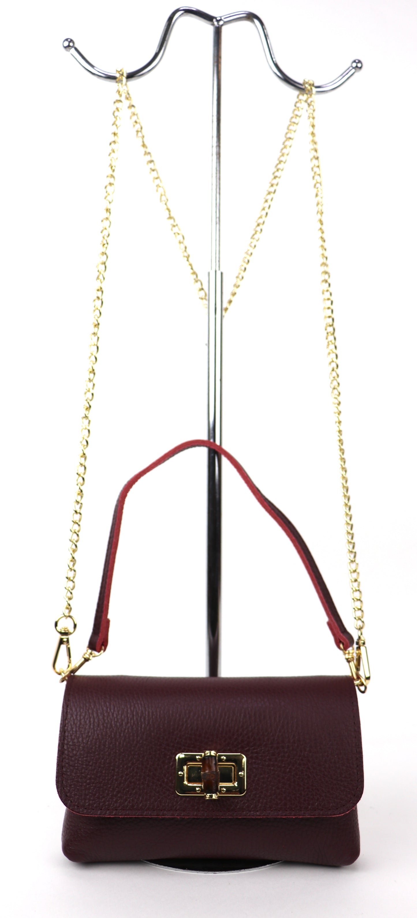 Burgundy leather bag hanging from a gold chain, showing its full silhouette.