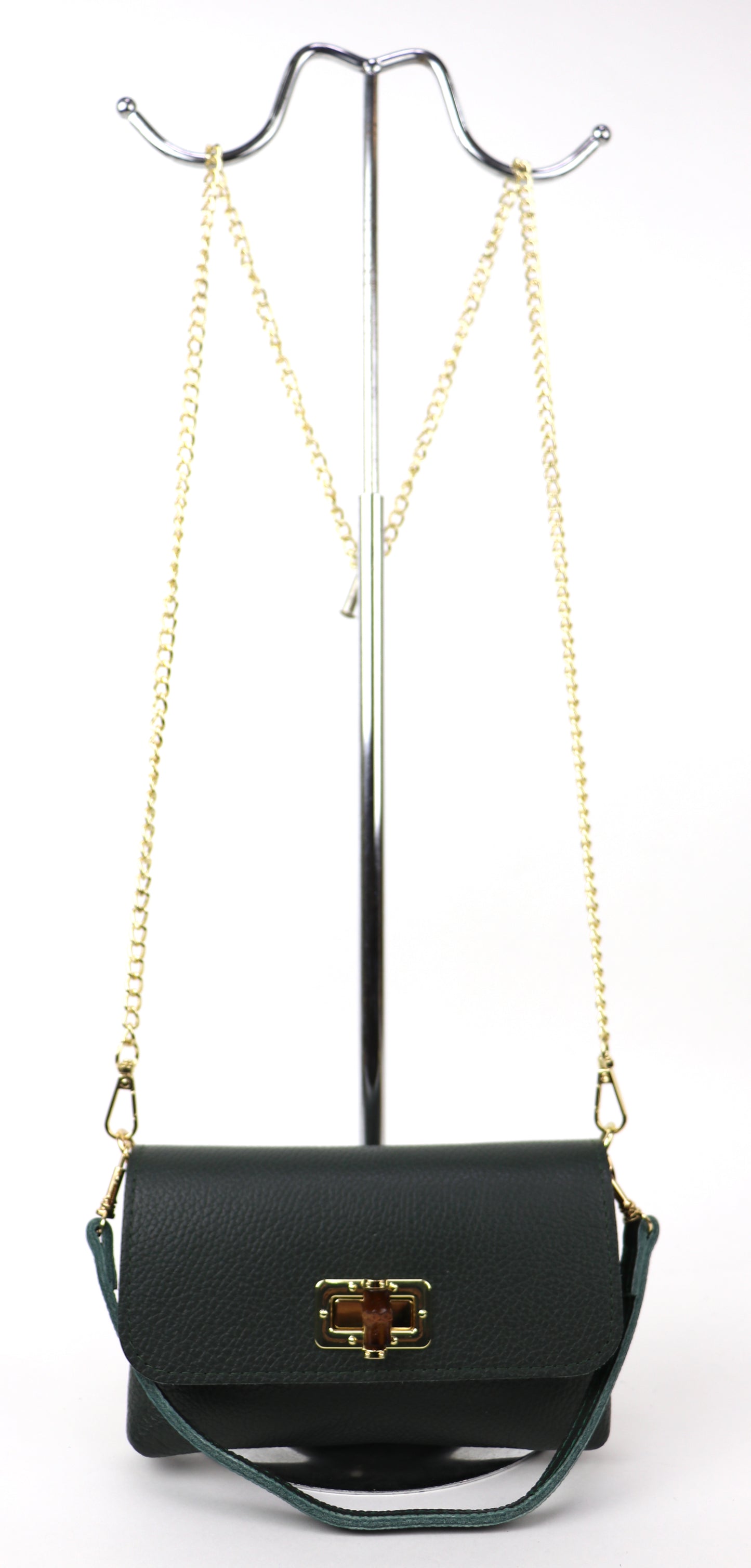 Dark green leather bag hanging from a gold chain, displaying its full silhouette.