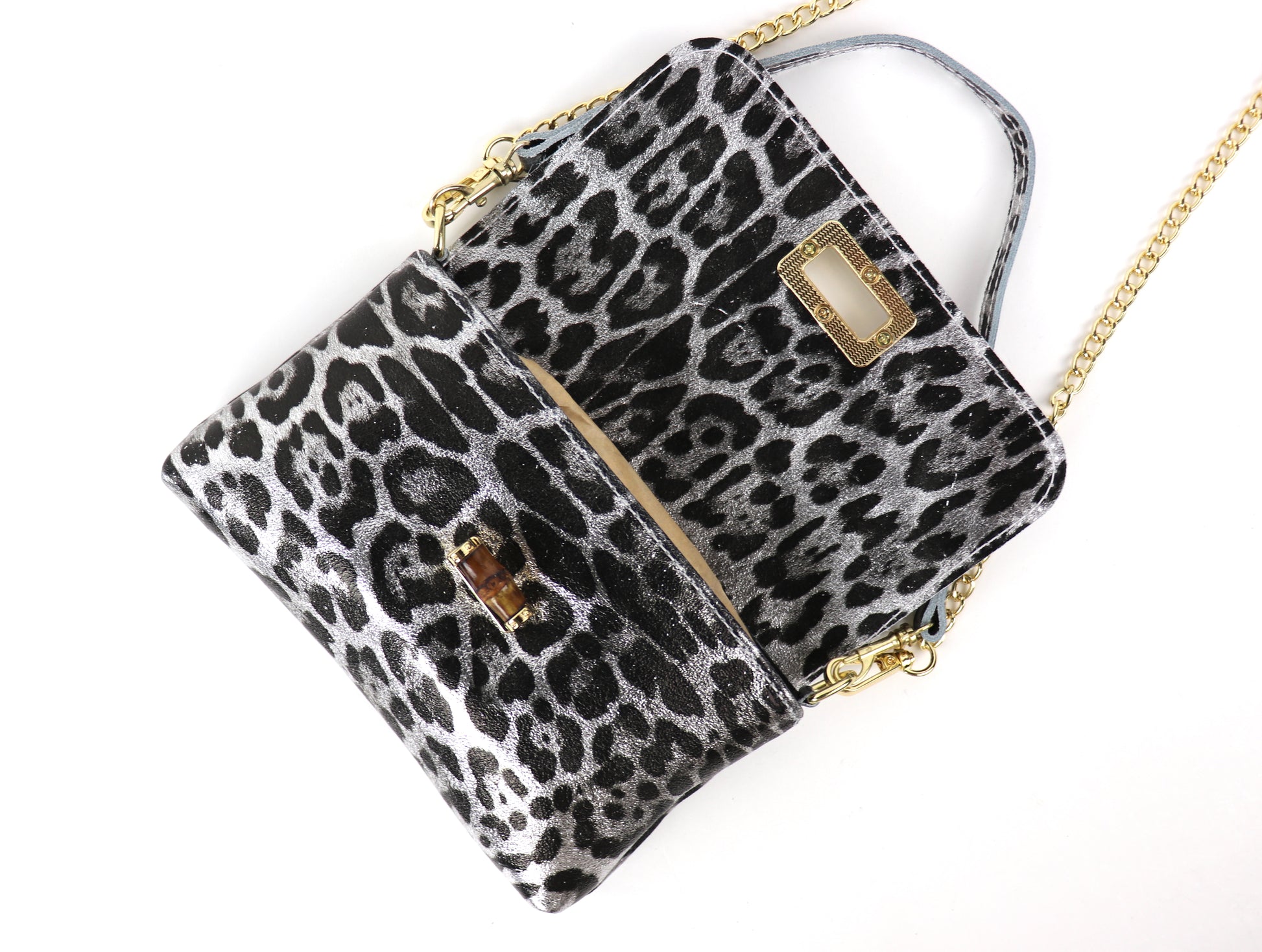 Open silver leopard print leather bag, displaying the interior space and compartments.