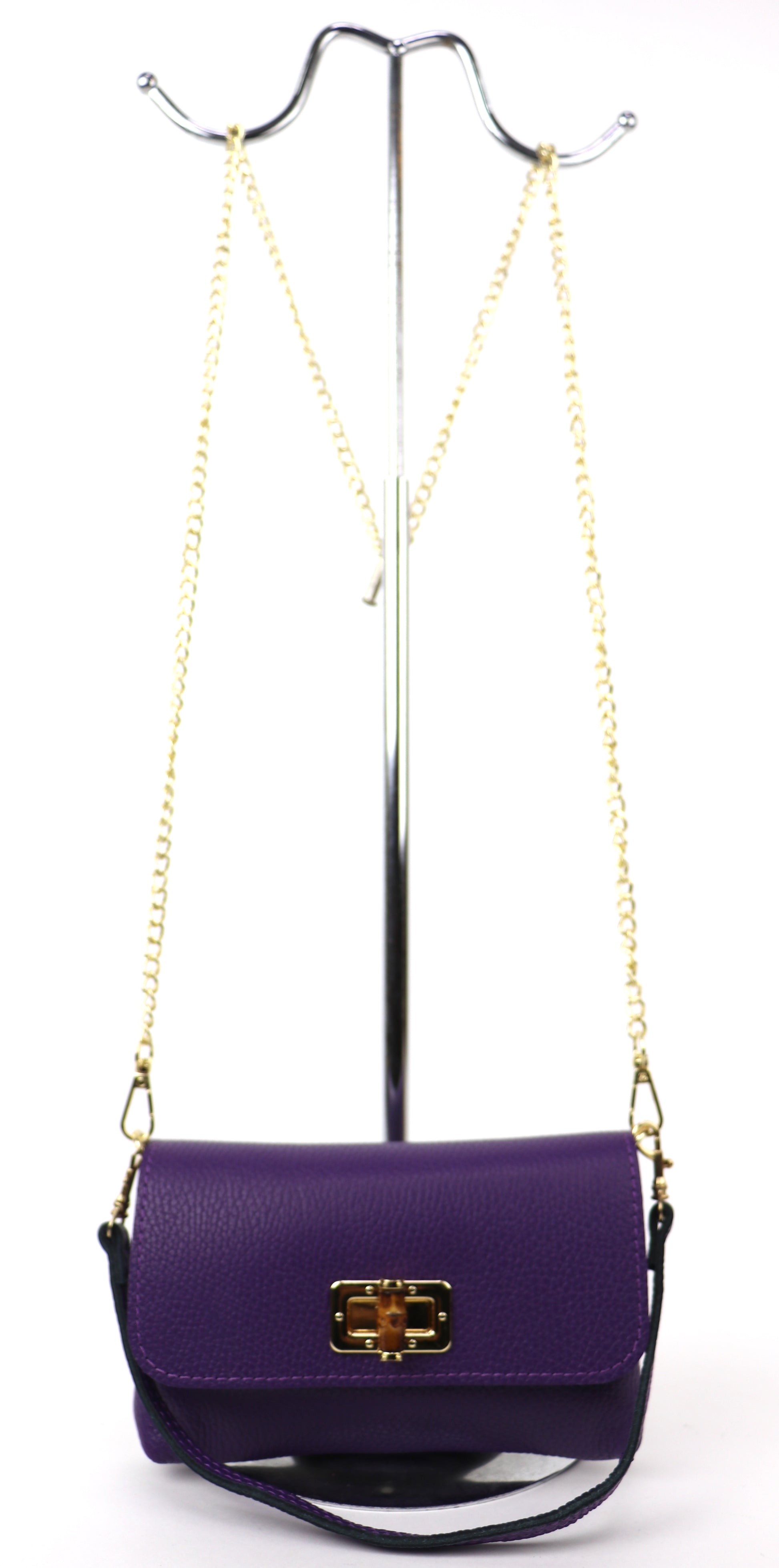 Purple leather bag hanging from a gold chain, displaying its full silhouette.