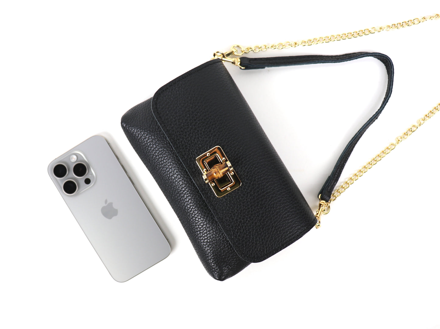 Black Leather Bag: Black leather bag with a gold chain, shown at an angle with a smartphone.