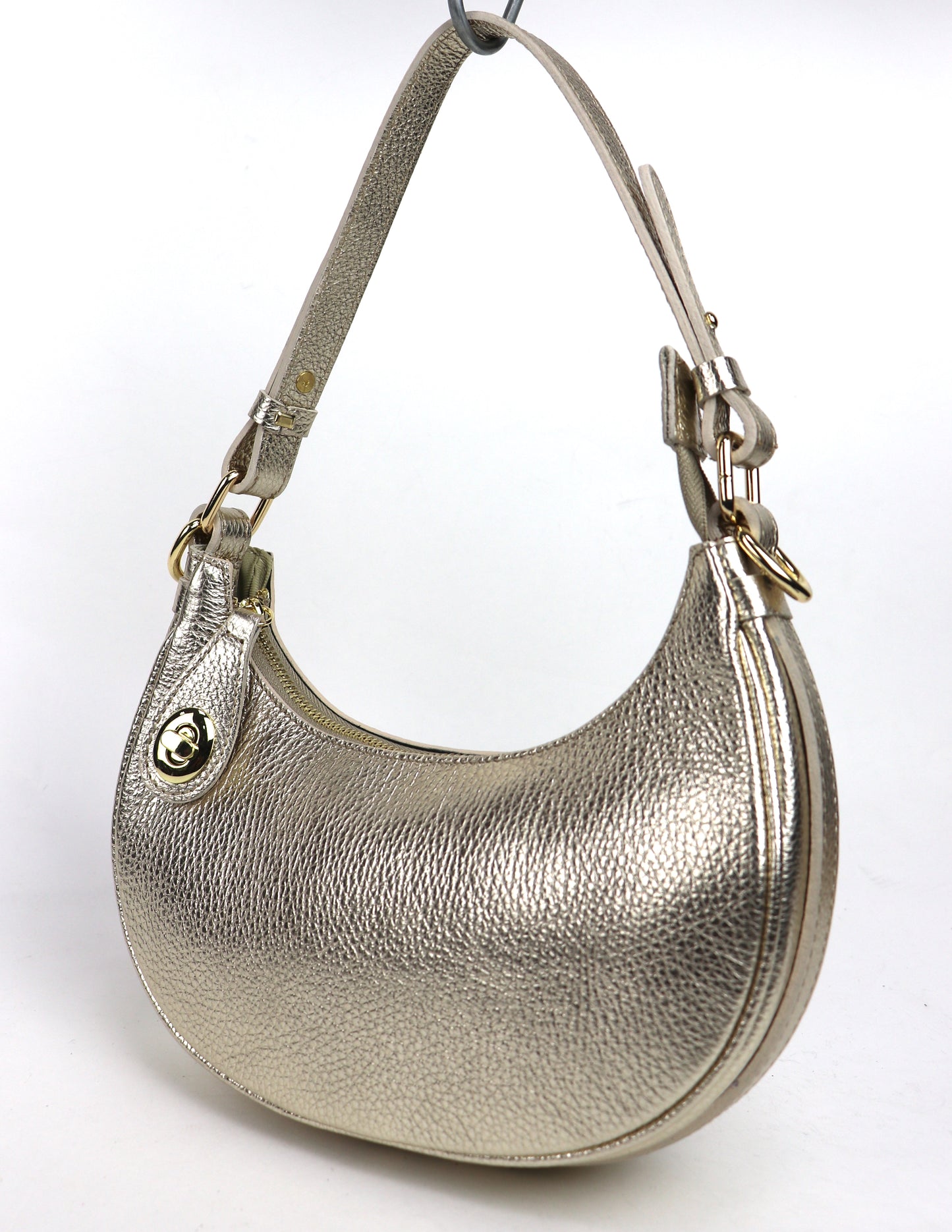 Gold small half moon shoulder/crossbody bag, angled side view, featuring metallic pebbled leather texture, gold-tone hardware, and adjustable strap displayed against a white background.

