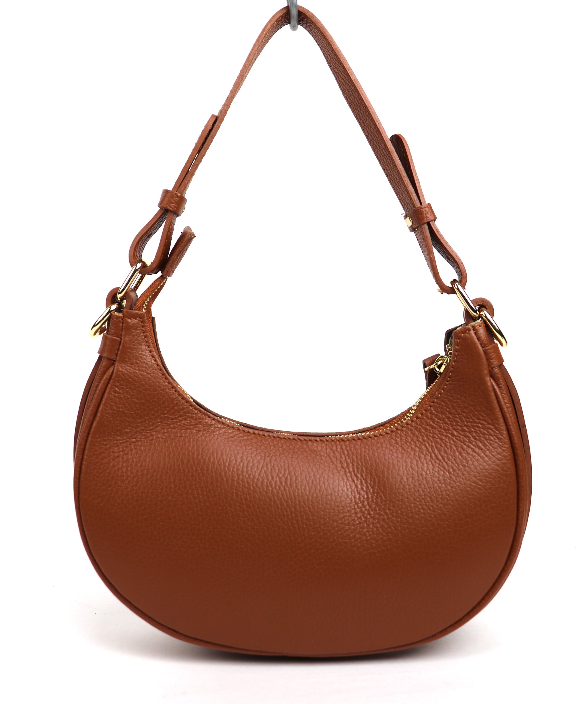 Tan small half moon shoulder/crossbody bag, front view, featuring pebbled leather texture, gold-tone hardware, and adjustable strap displayed against a white background.

