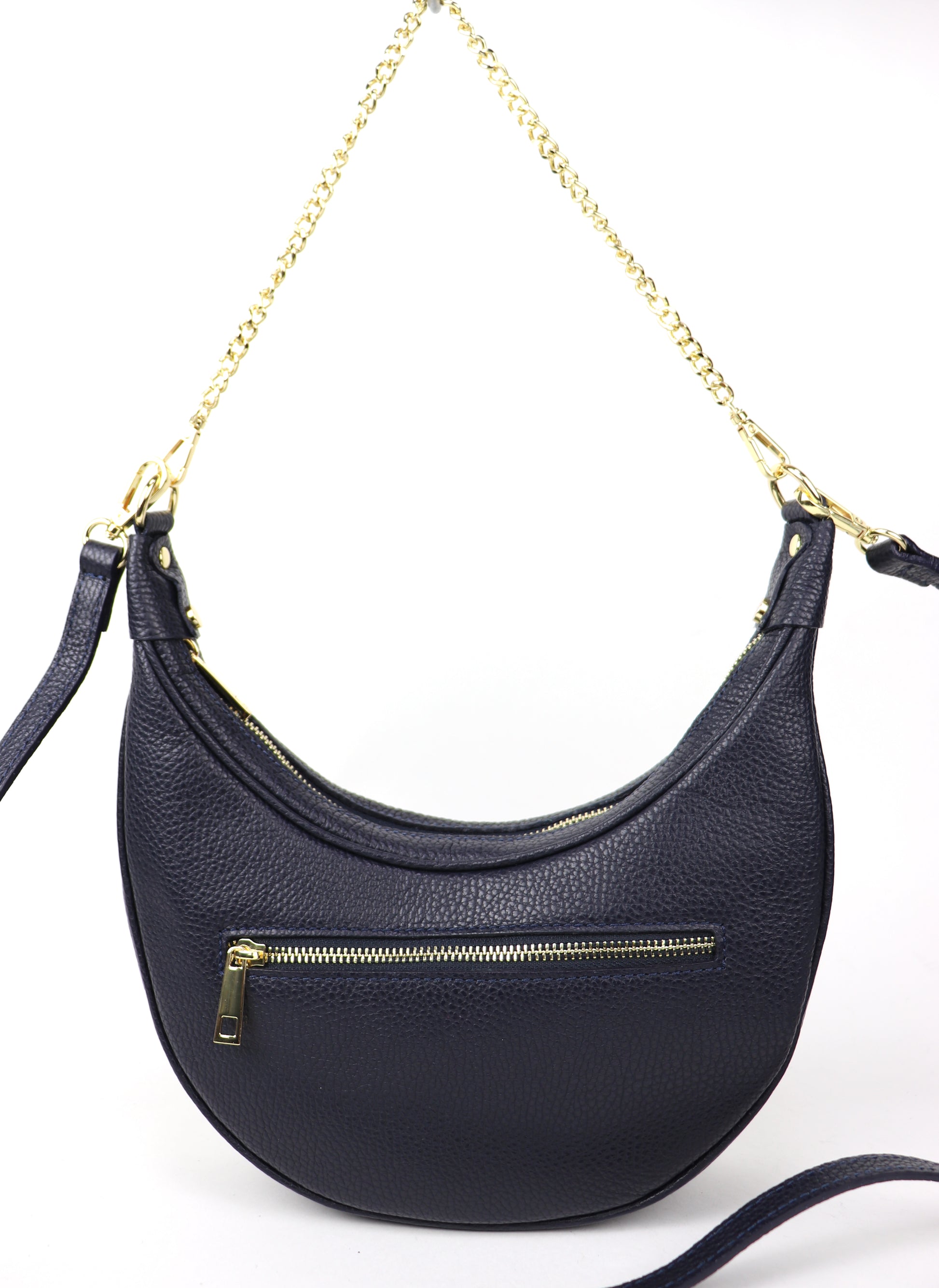 A navy crescent-shaped leather crossbody bag with a gold chain strap, shown from the back. The bag features a gold zipper pocket, providing additional storage, and is photographed against a white background.