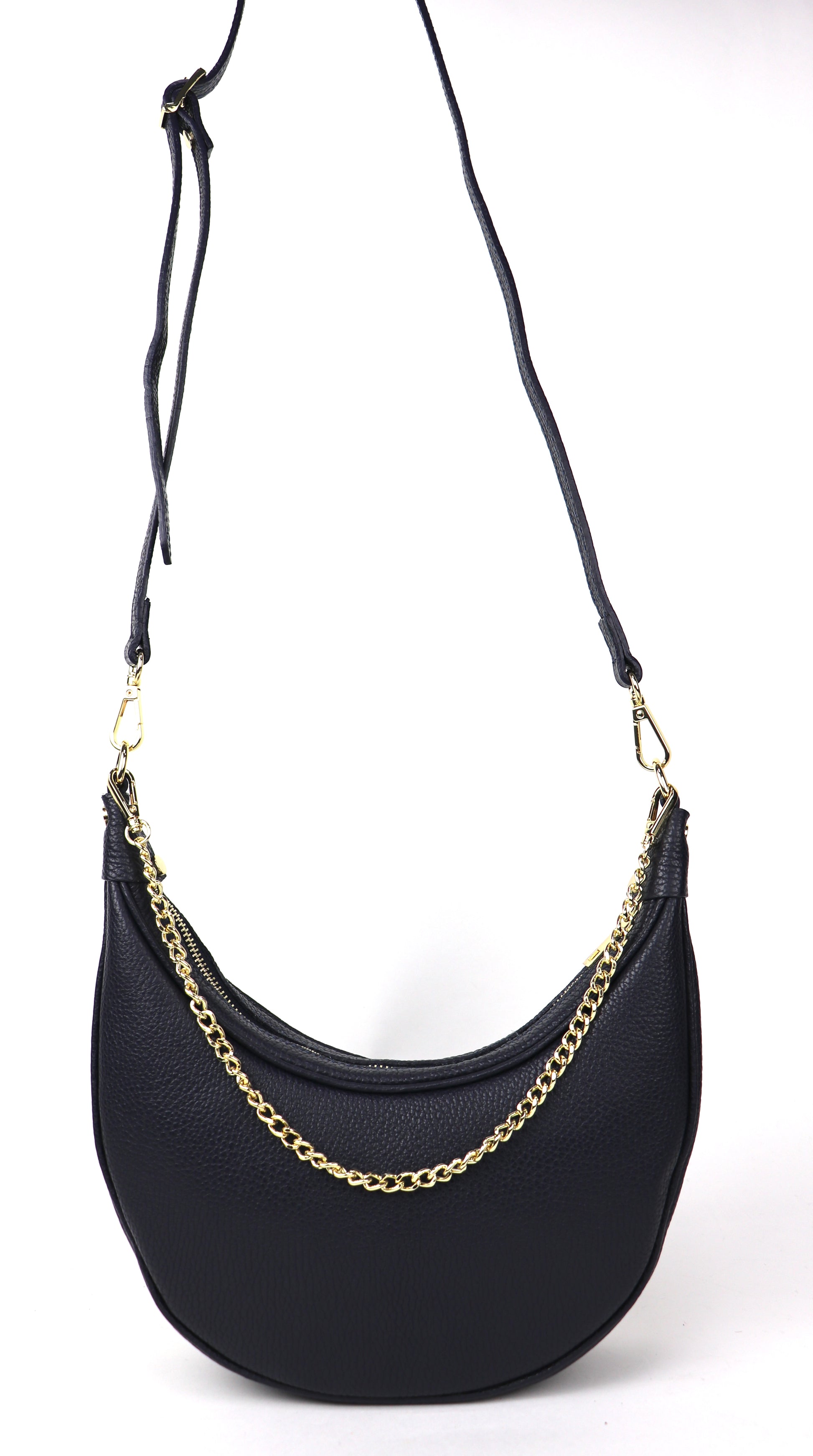 A navy crescent-shaped leather crossbody bag with a gold chain strap and a longer adjustable leather strap, photographed from the front against a white background. The long strap is shown hanging, offering versatility in how the bag can be worn.