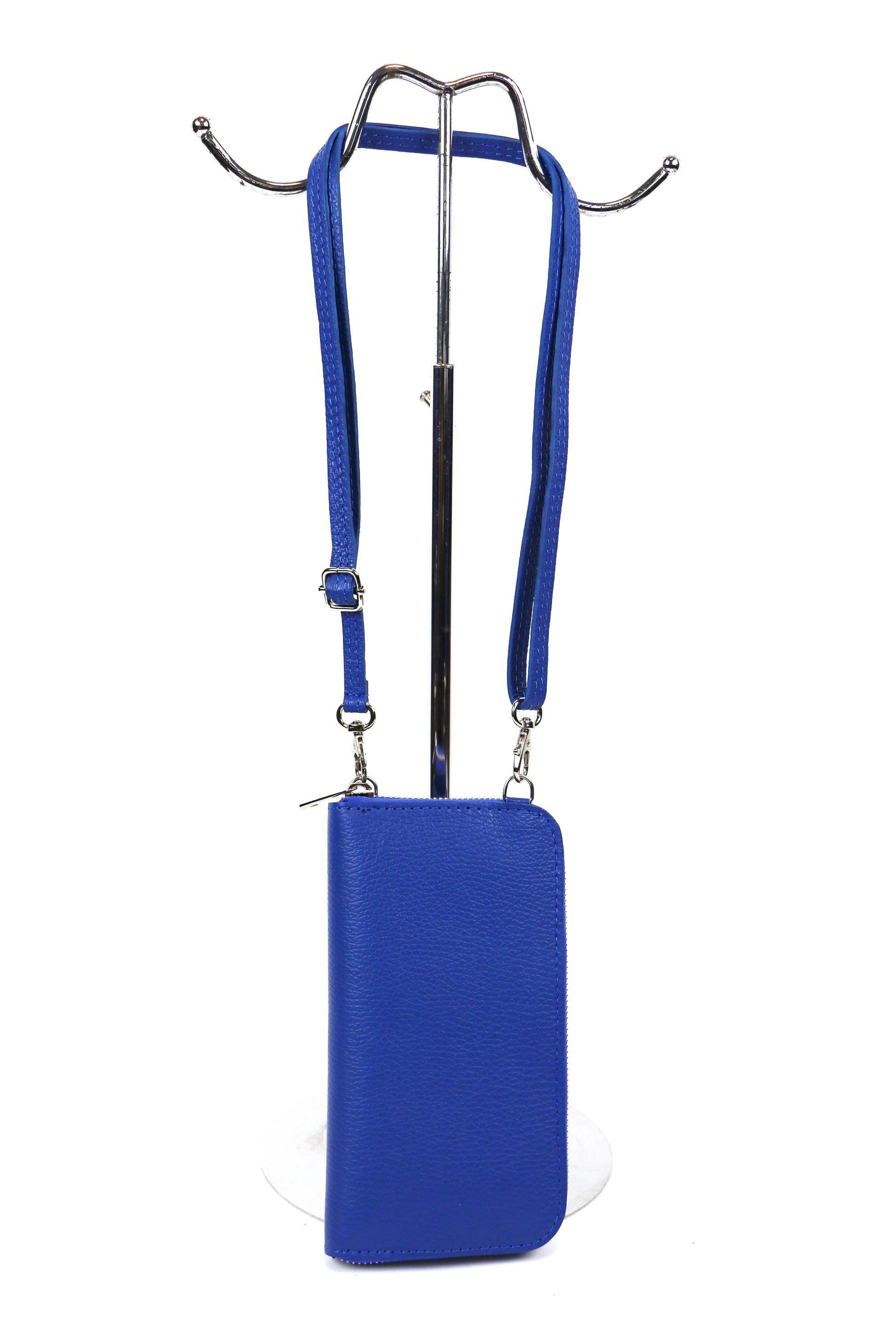 Another front view of the royal blue crossbody bag displayed on a stand with straps.