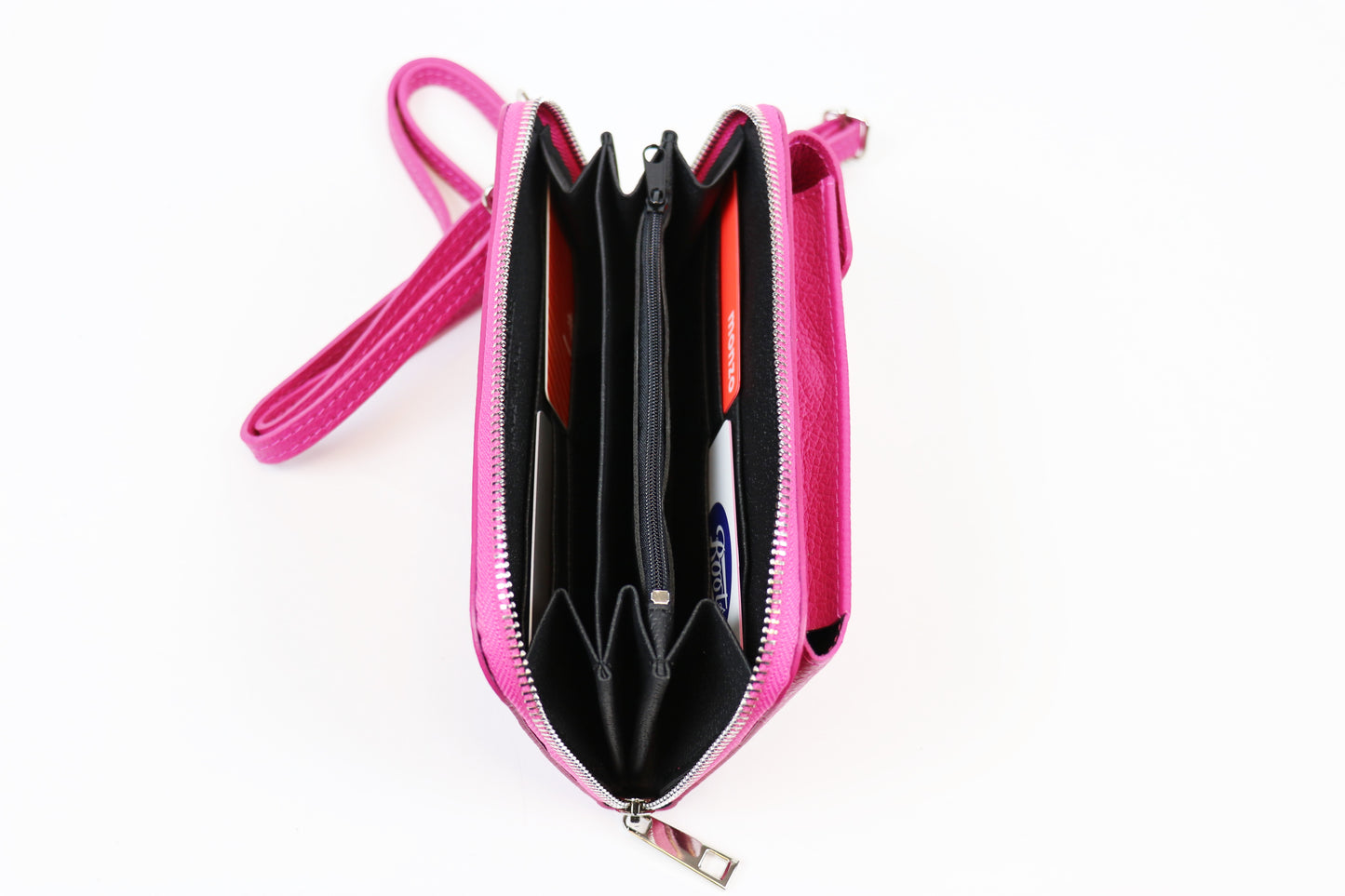 Open pink crossbody bag displaying multiple compartments with cards stored inside and a pink strap attached.






