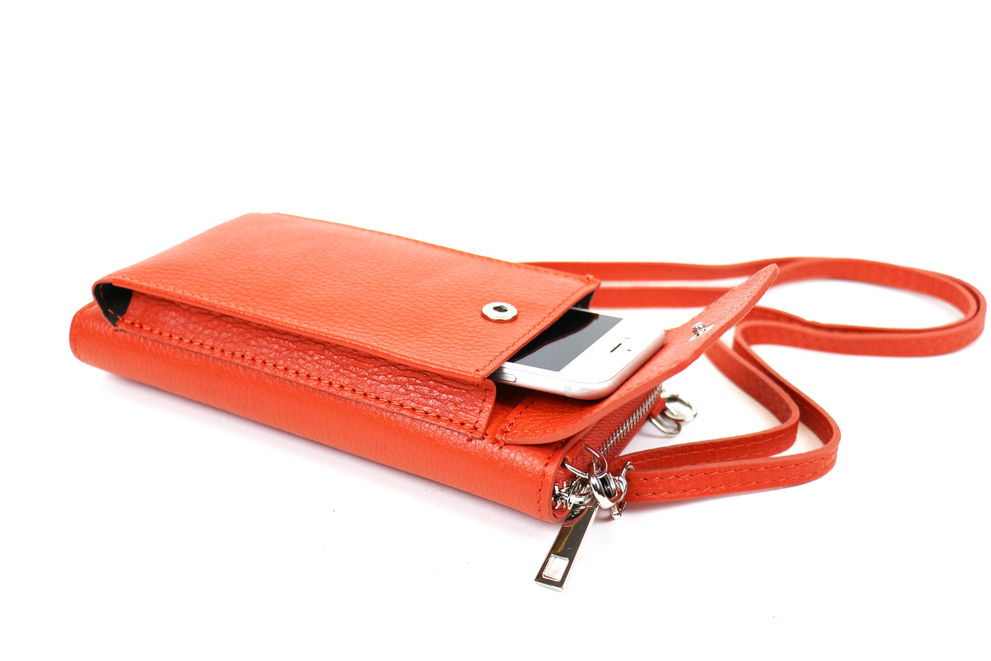 Orange crossbody bag with a phone partially inserted into the front flap pocket and an attached pink strap.






