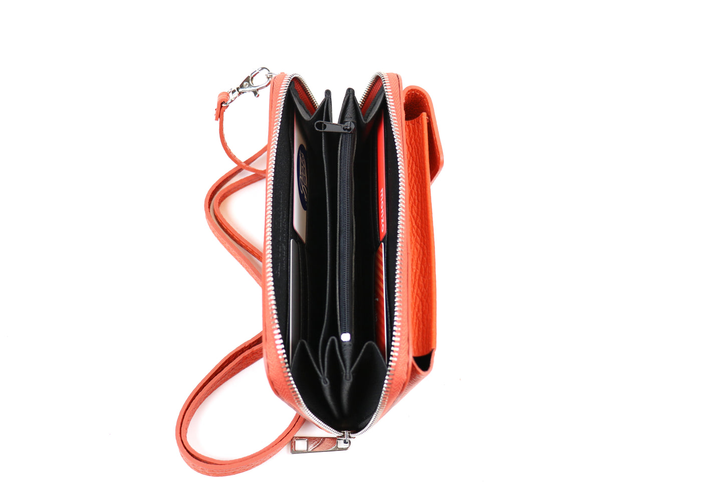 Open orange crossbody bag displaying multiple compartments with cards stored inside and an attached orange strap.












