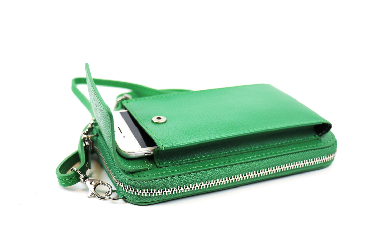 Green crossbody bag with a phone partially inserted into the front flap pocket and a visible zipper, with an attached green strap.






