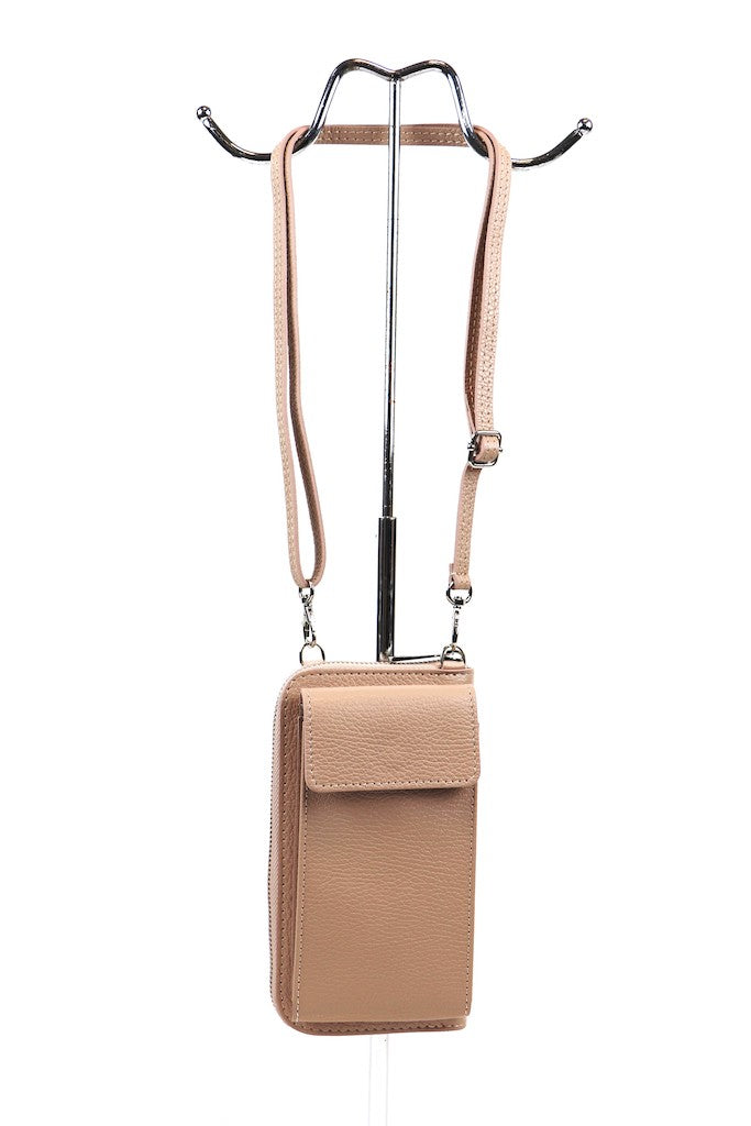 Light Brown leather crossbody bag with adjustable strap hanging on a metal stand.