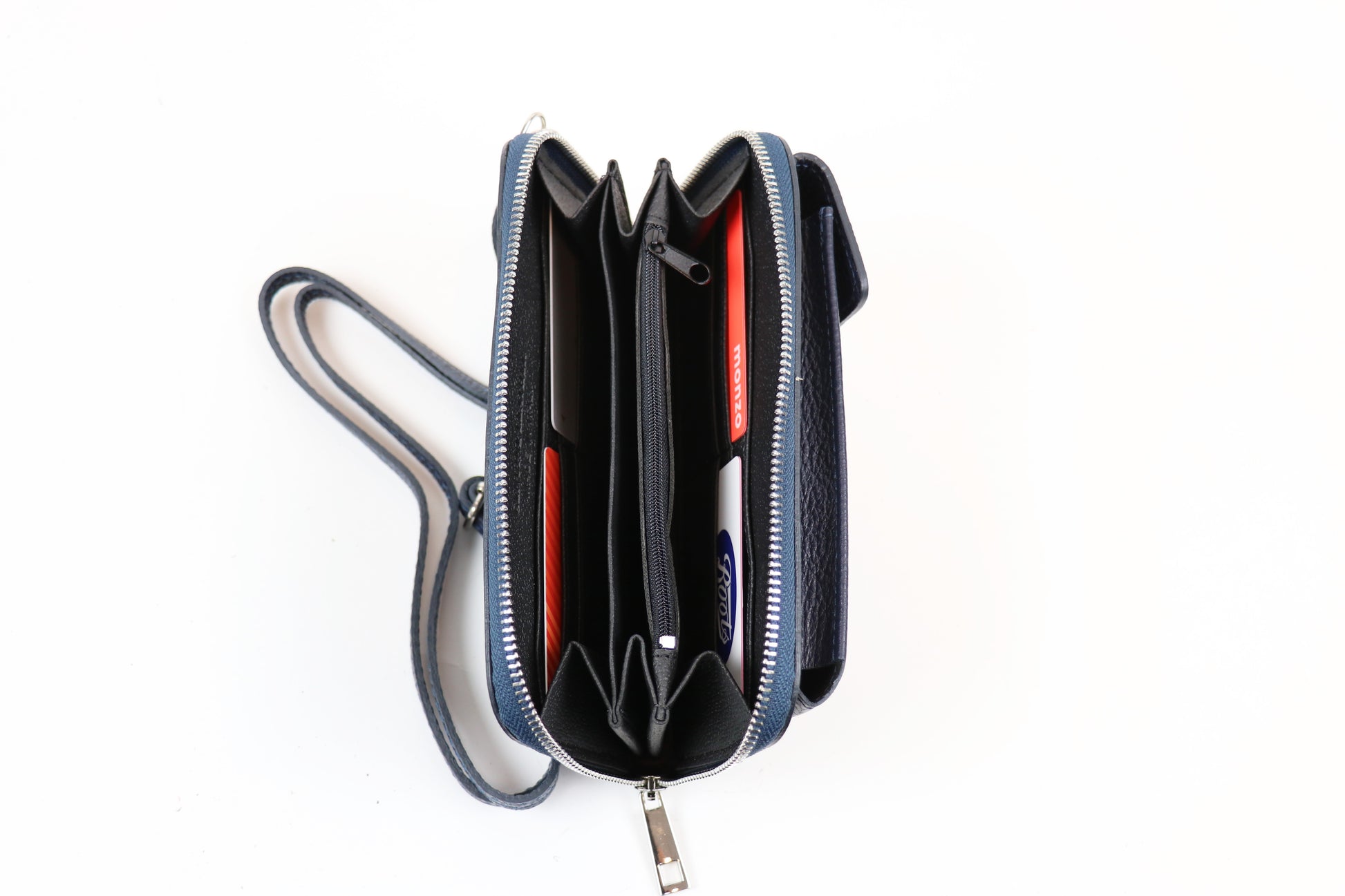 Navy blue crossbody bag opened to reveal multiple compartments with a strap displayed beside it.