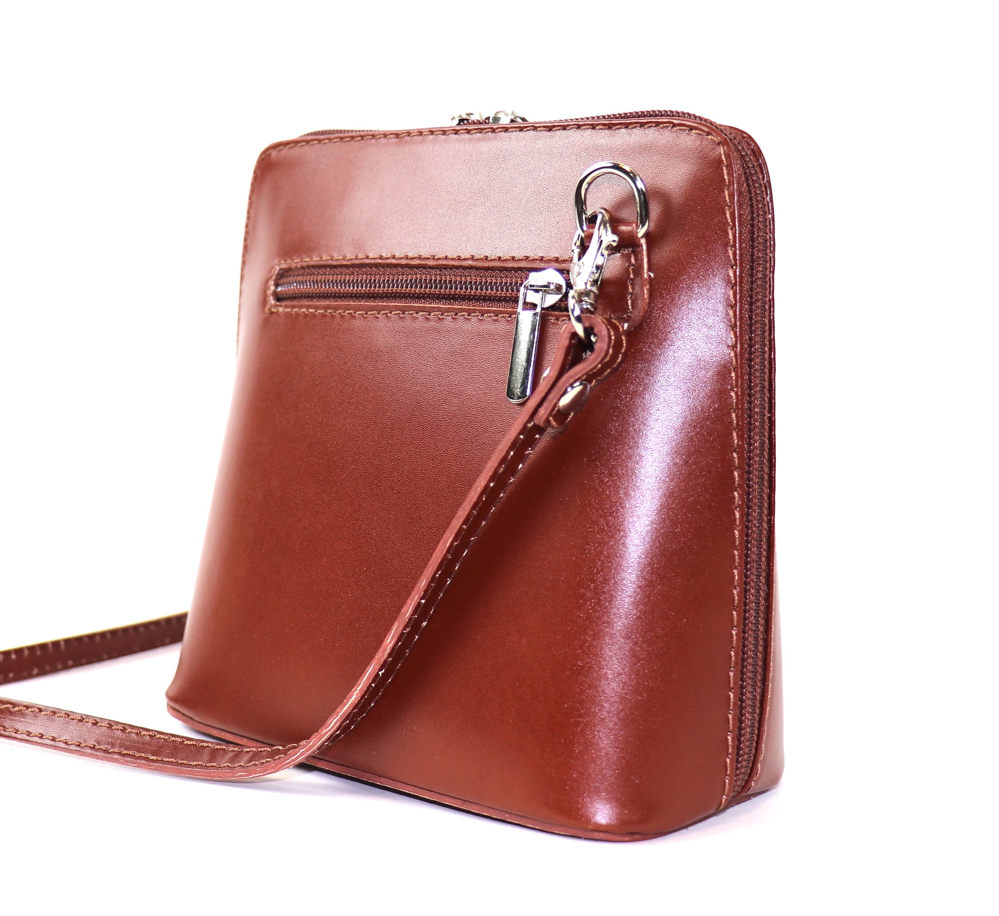 Tan Small Handmade Leather Crossbody Bag, top view showing the interior compartments with items inside.
