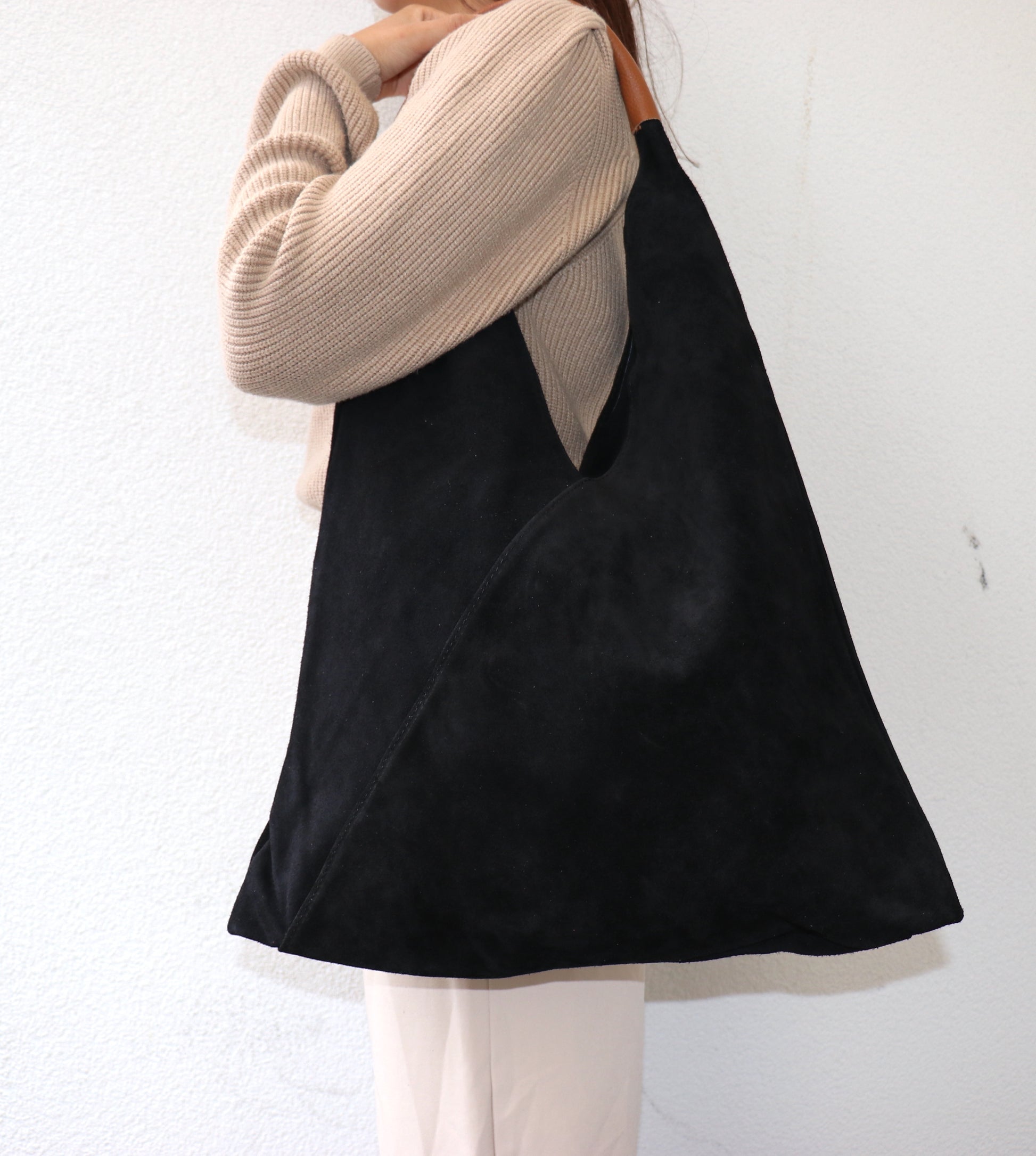 Model wearing the Black Samantha Tote over the shoulder.
