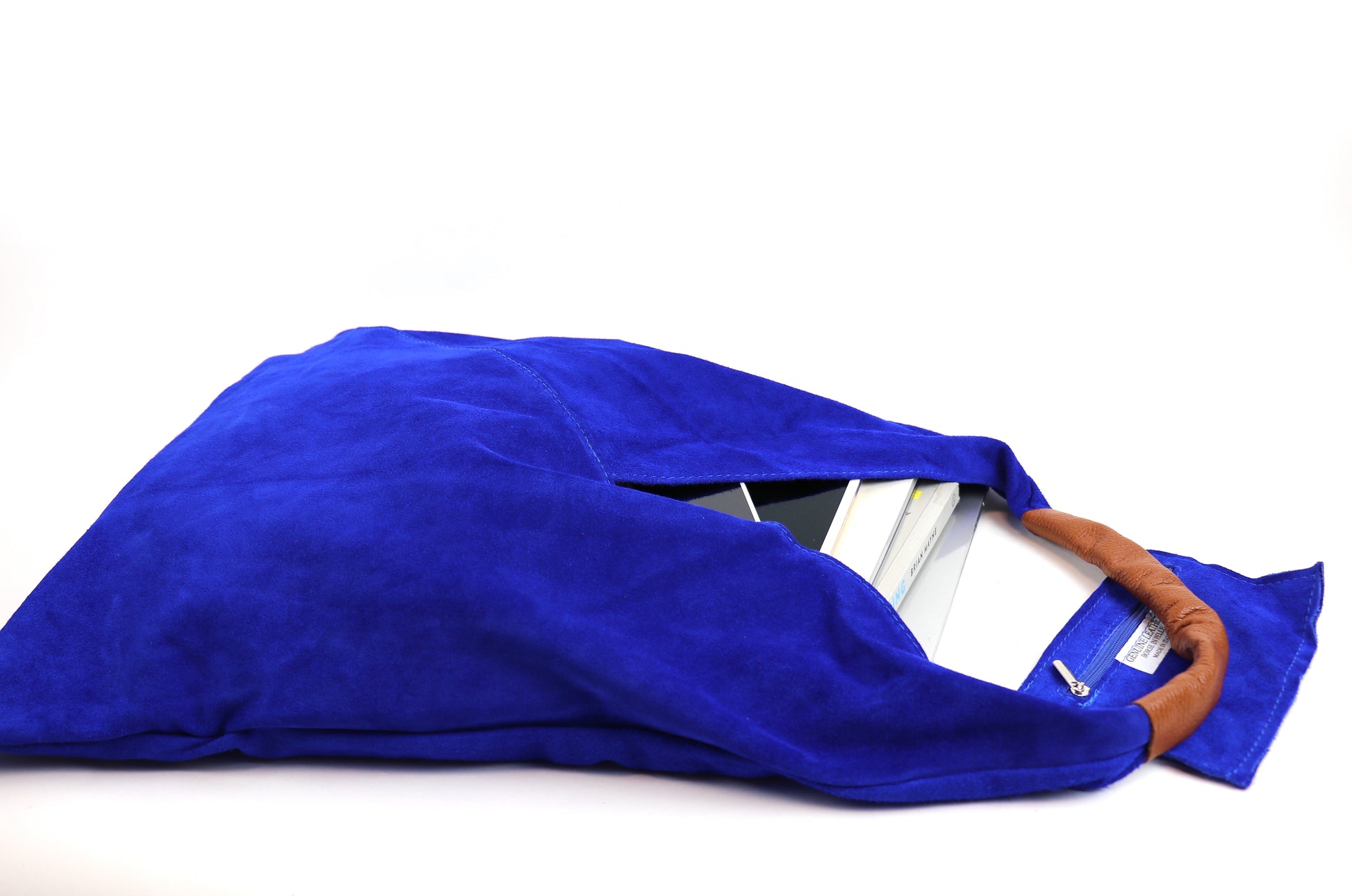 Close-up of the Royal Blue Samantha Large Tote Laptop Bag showing a tablet inside and brown leather handles on a white background.